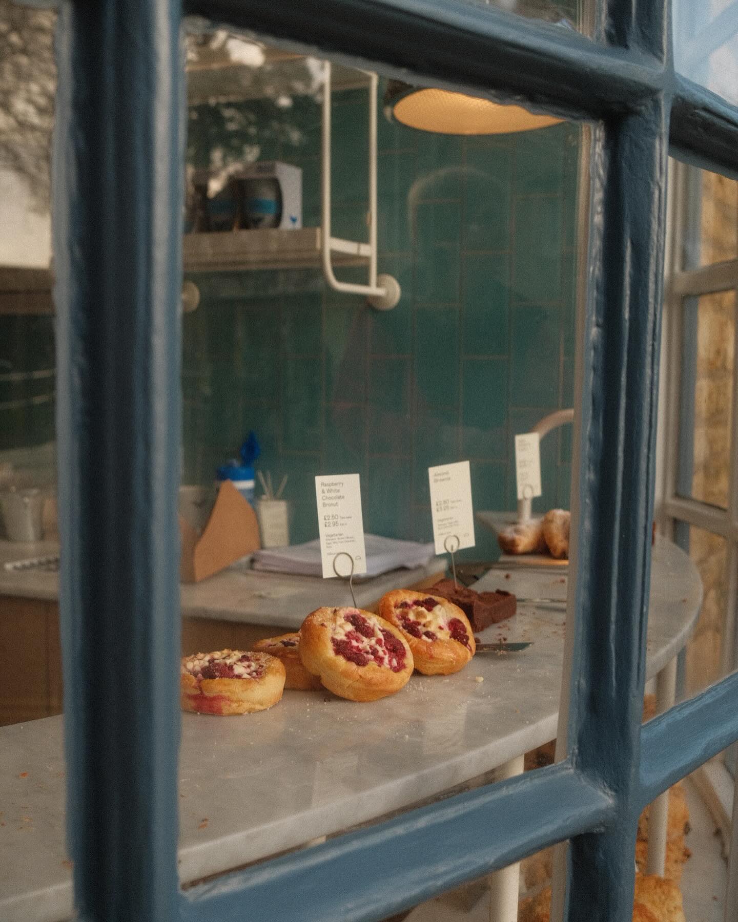 Pastries in a window of a pattiserie shop in Bourton-on-the-Water Cotswolds