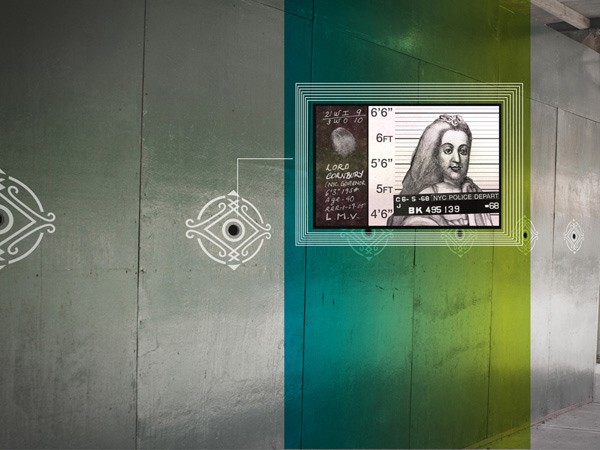A grayscale image of a woman with long hair, wearing a headpiece, displayed on a screen. The screen shows text including “LORD GODFREY,” “2/5/1958,” “6’6”,” “6’FT,” “5’6”,” “5’FT,” and “4’6””. The screen is framed by concentric circles and overlaid with geometric patterns. The background consists of gray and green concrete walls with circular white designs.