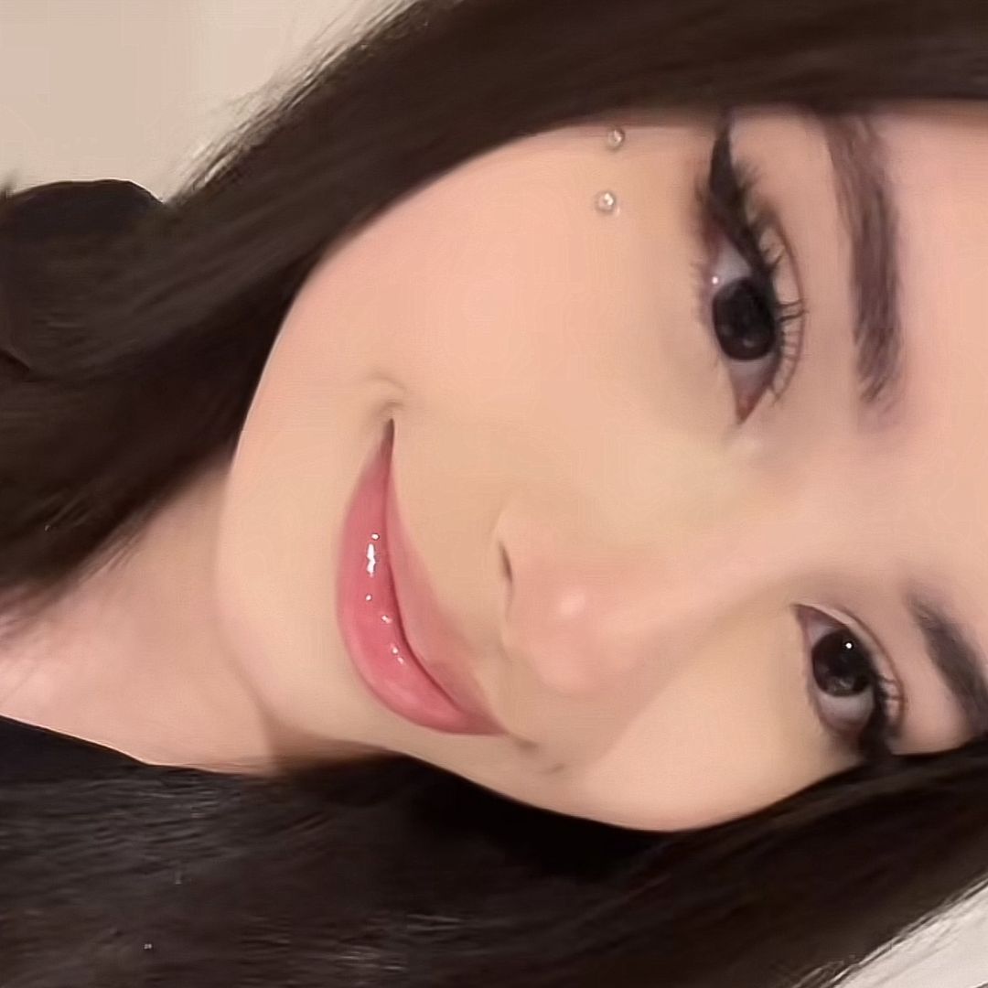 a man with a goatee smiles at the camera