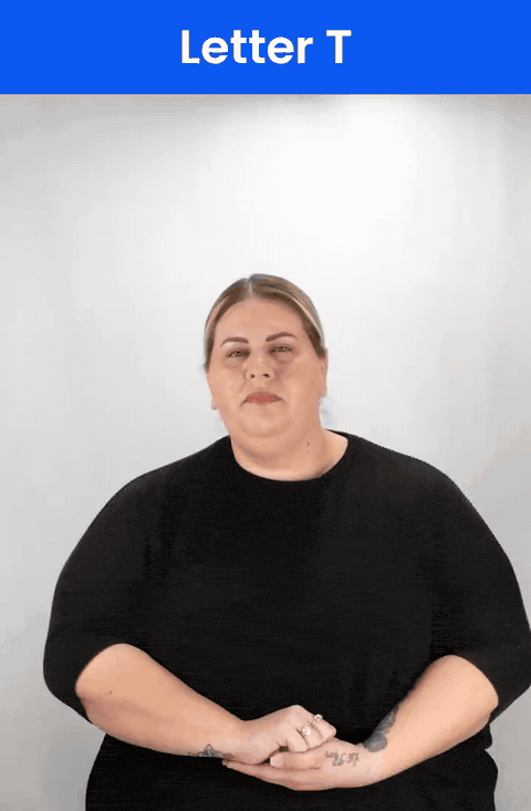 Animated GIF: a Deaf signer signs T in ASL, a fist with the thumb tucked between the index and middle fingers.