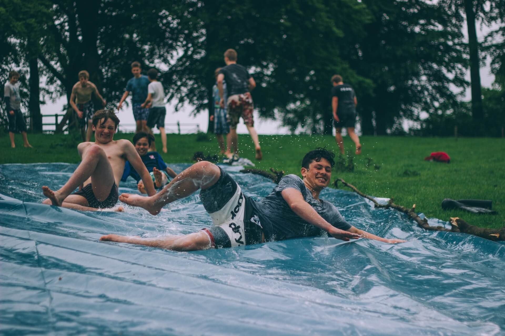 Kids sliding down an outdoor slide