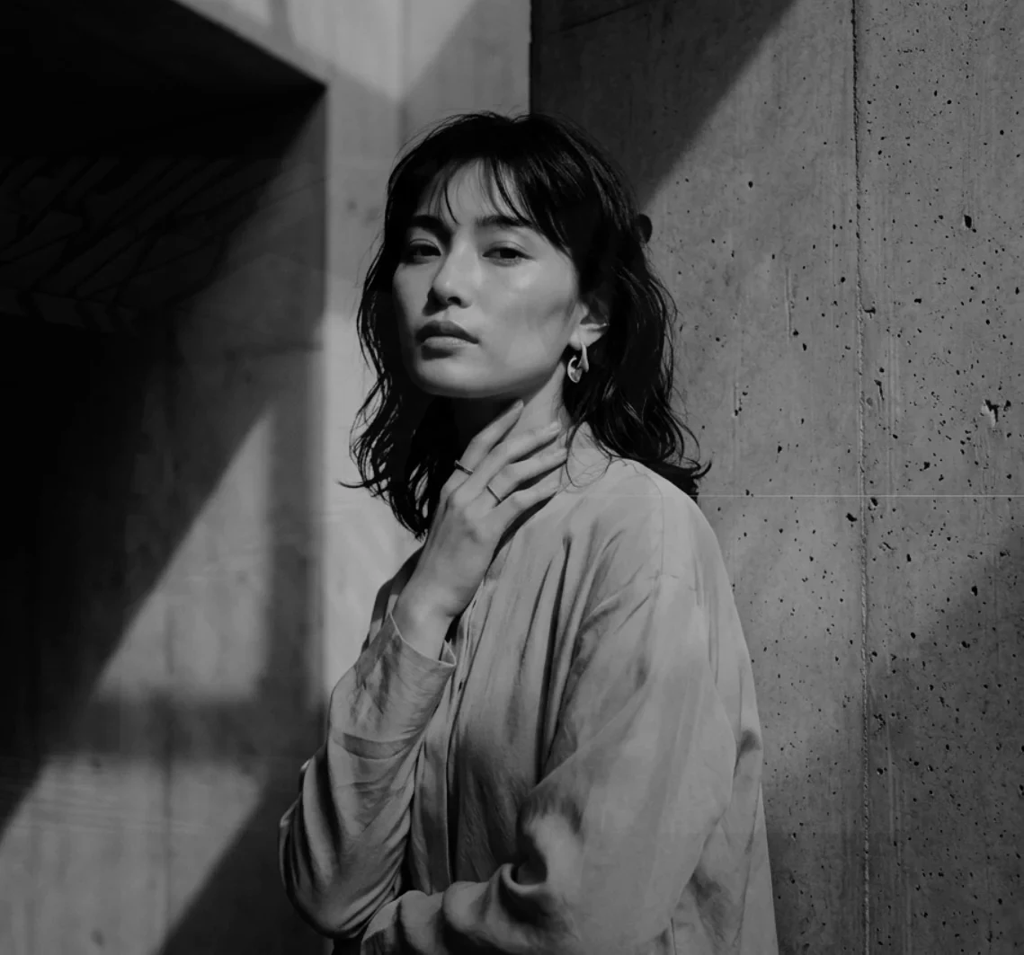 Portrait against a sunlit concrete wall