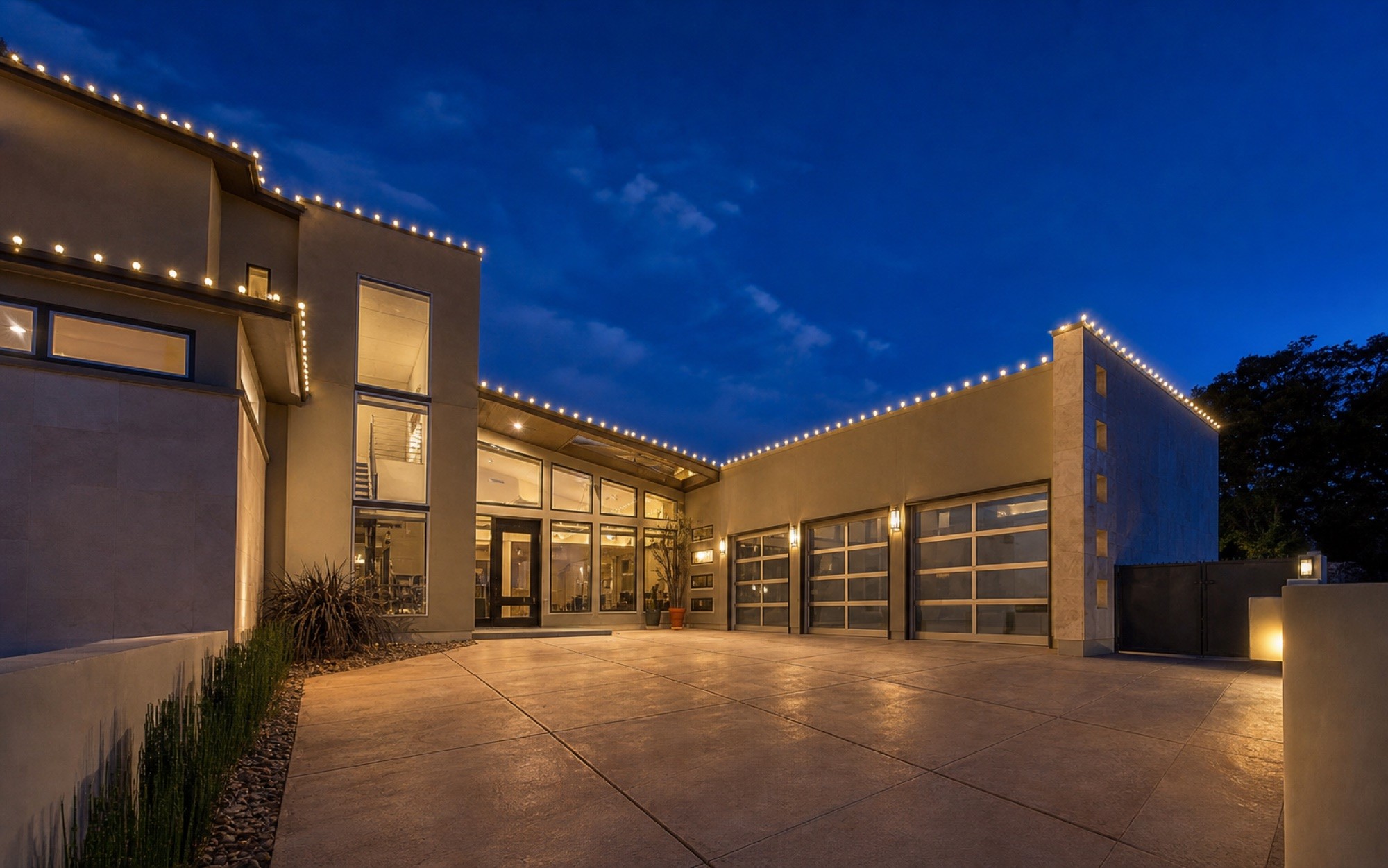 Large-frontage motor court and glass bays lit end to end