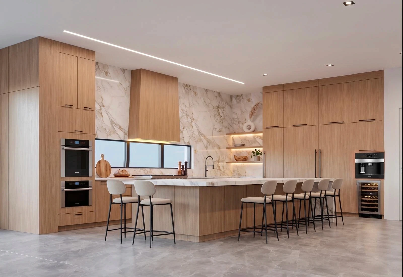Contemporary kitchen with warm wood cabinets, Calacatta marble backsplash and waterfall island, a tapered wood range hood, black fixtures, built-in ovens and wine fridge, and six cream bar stools along the island.