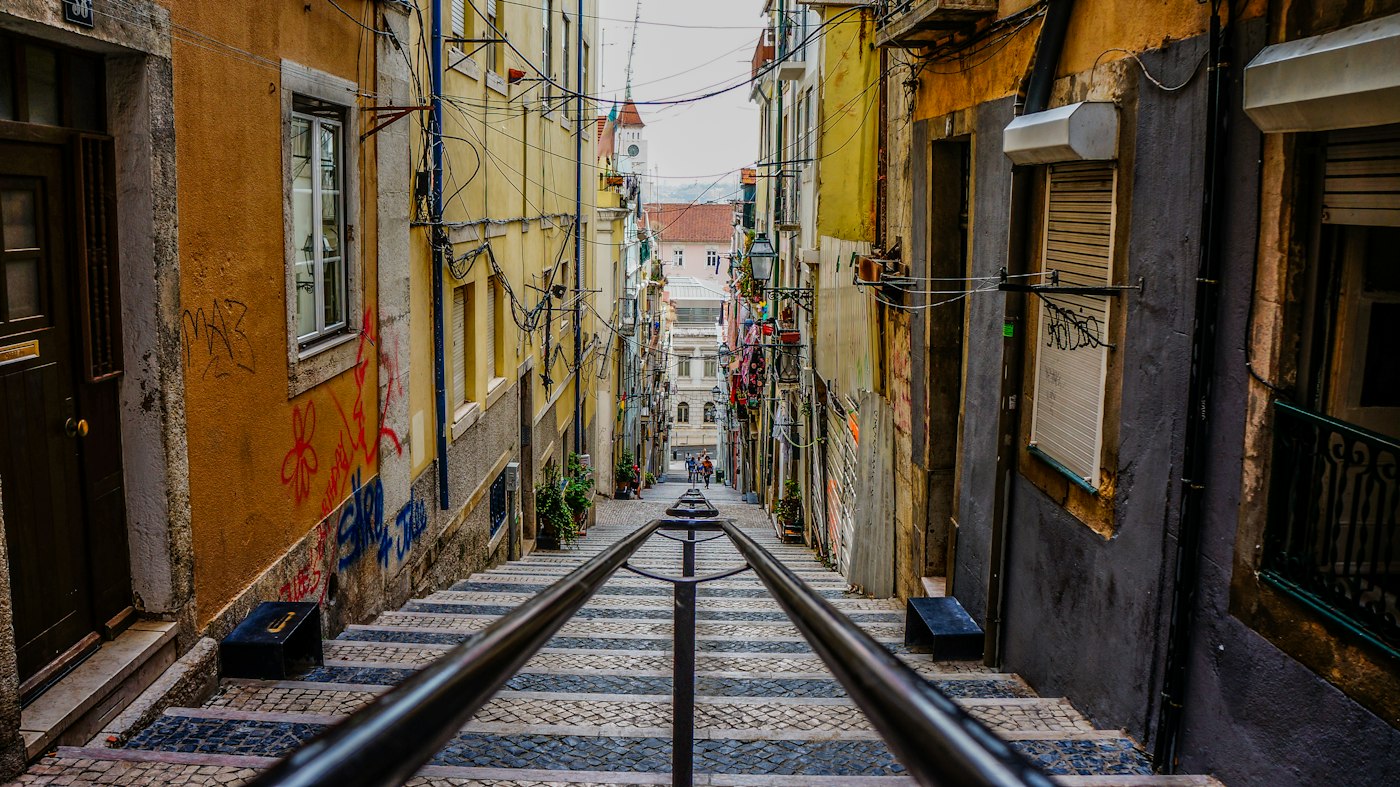 Tram tracks running down a narrow Lisbon street
