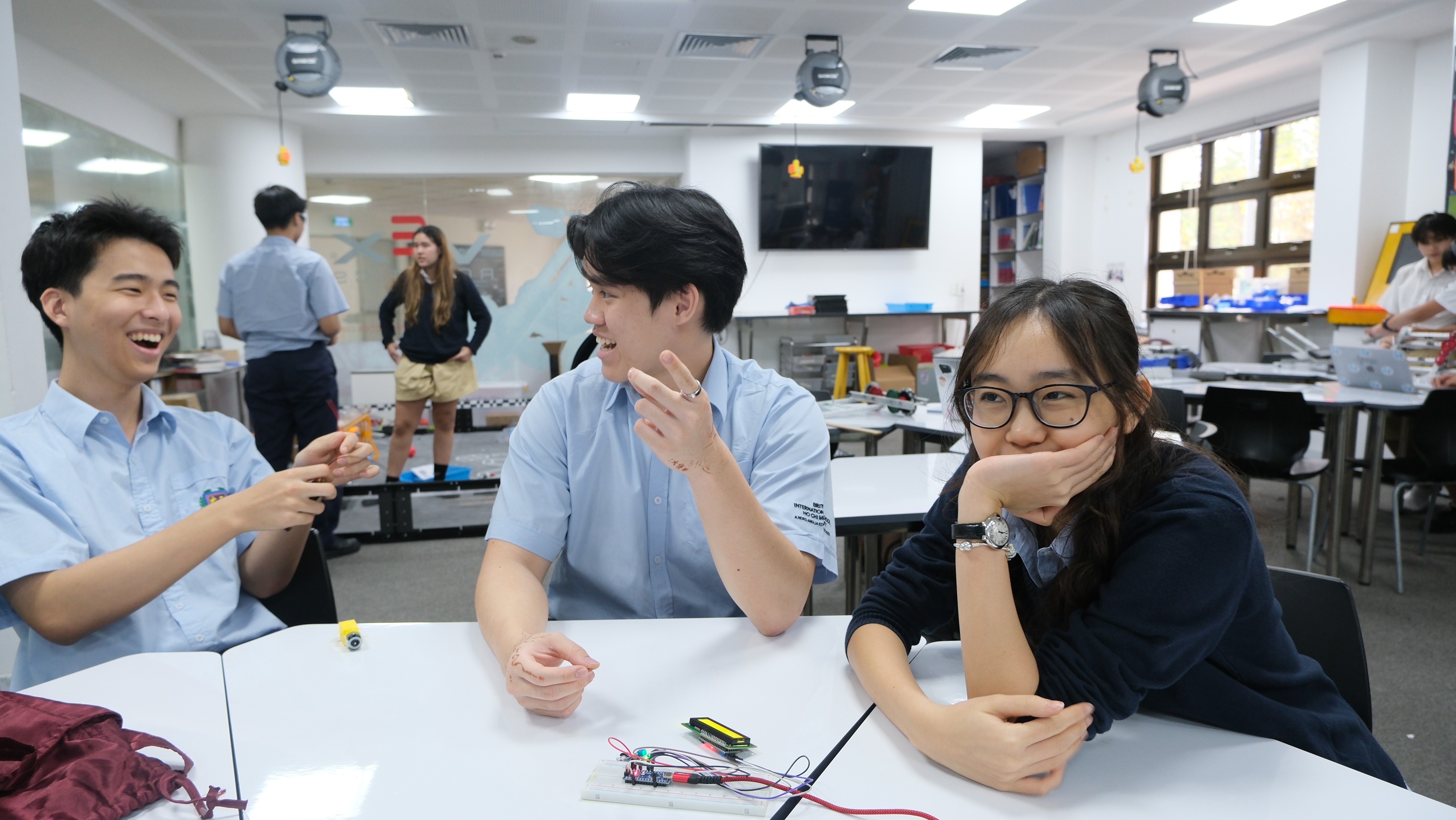 Hand in glove spraying colorful paint on wall