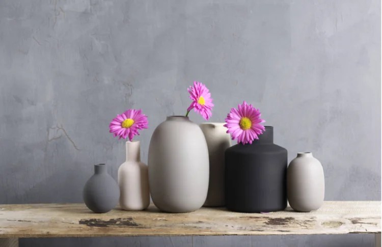A set of six differently shaped vases on a table
