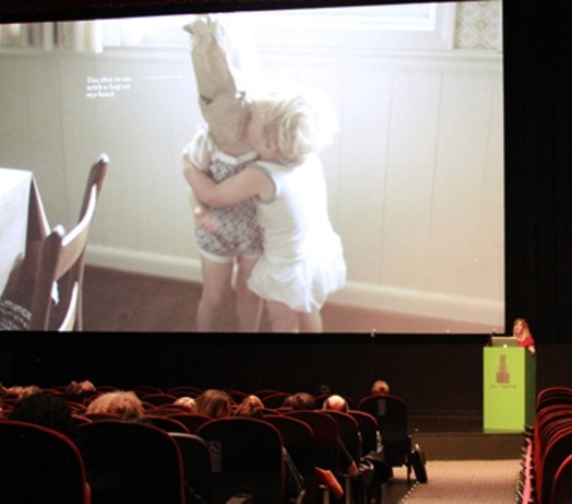 A photo of a screenshot showing two kids playing.