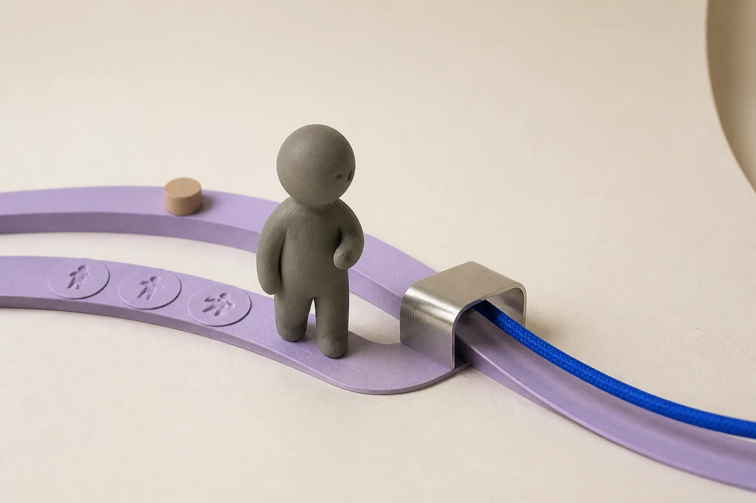 A matte-clay character stands where a cobalt cord passes through a metal guide beside two lavender paper tracks.