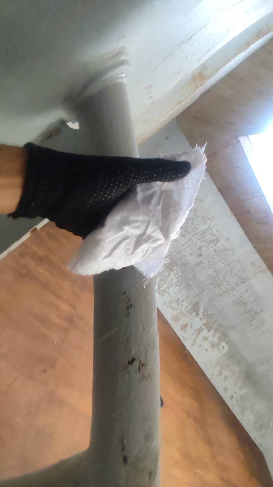 Seachios shore gang performing white-rag wipe check on hold structure after cargo hold cleaning (post-coal cargo).