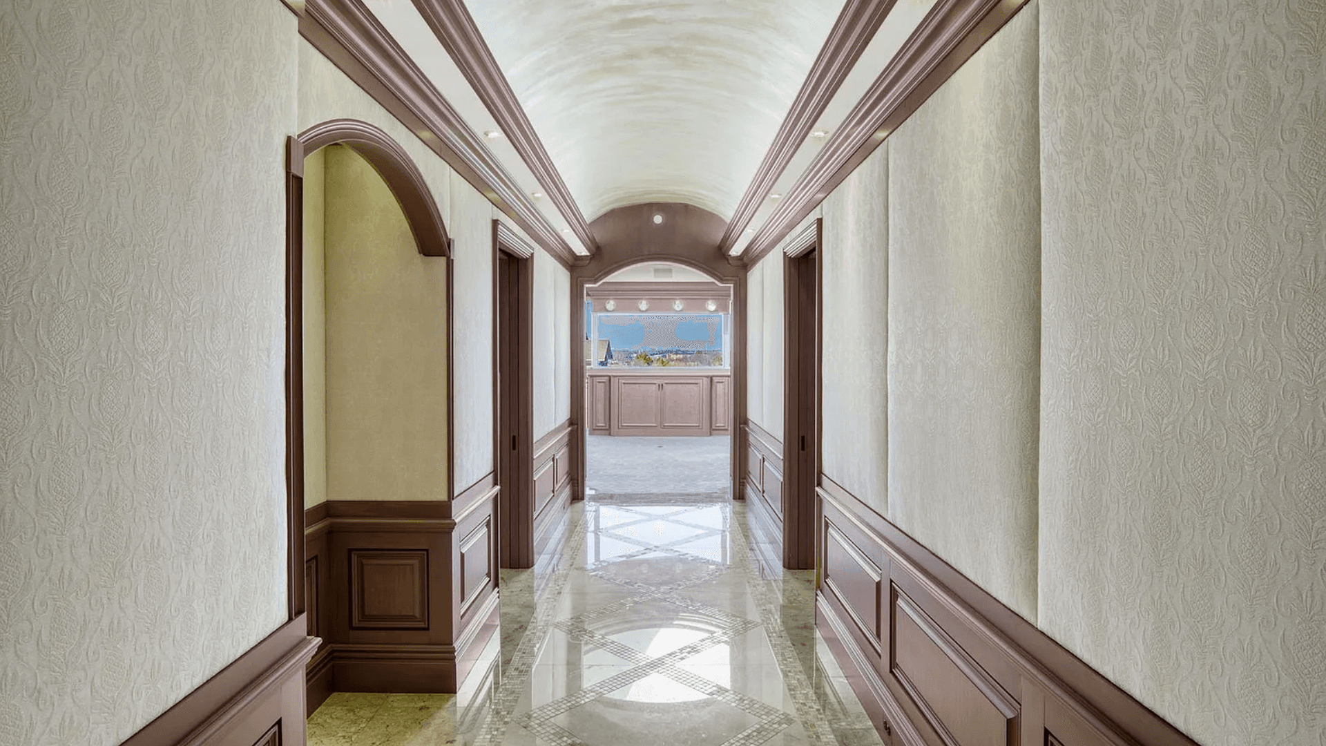 Elegant arched hallway at The Gateway Village apartments for rent, featuring detailed molding and luxurious finishes for a sophisticated entry.