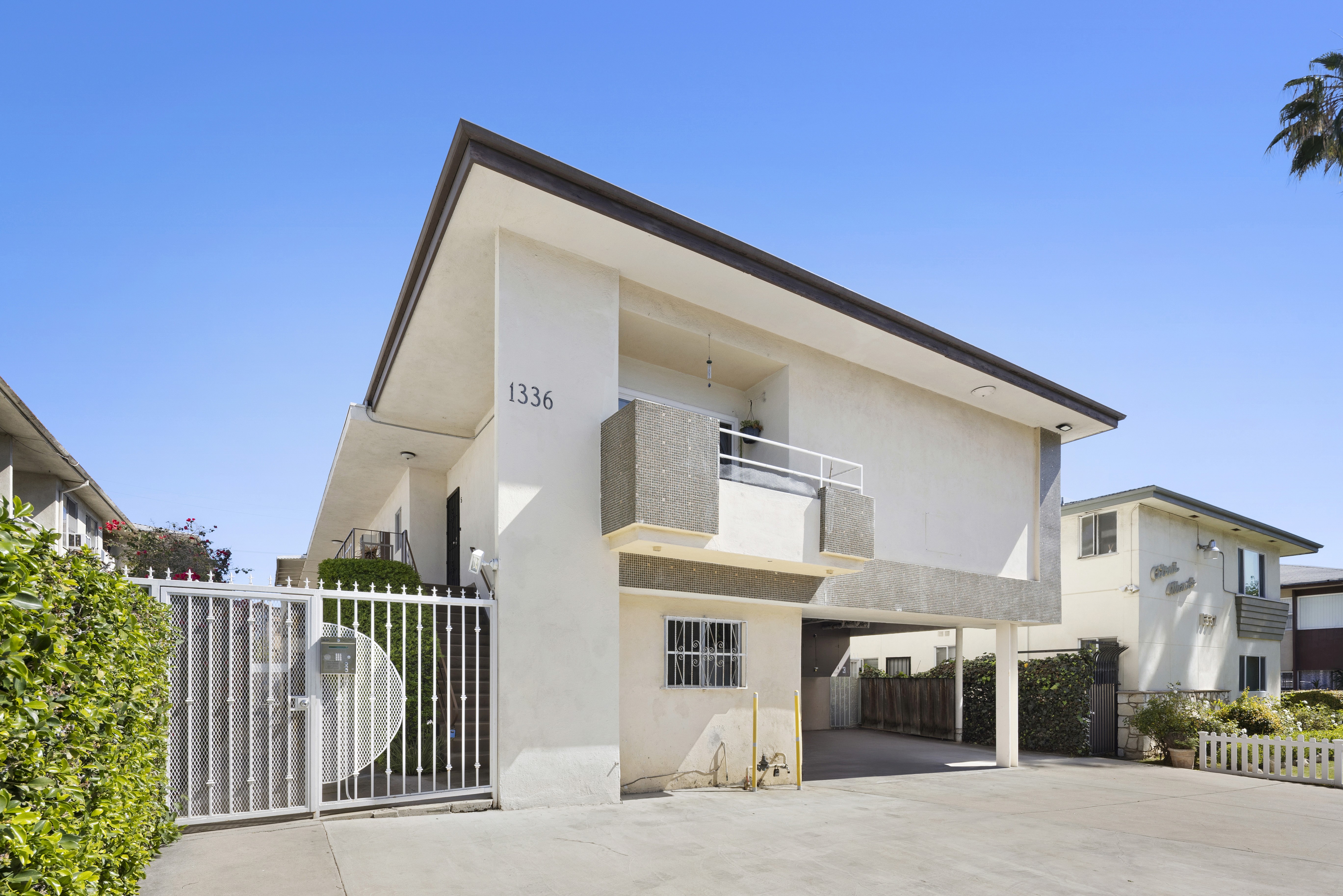 Angled exterior view showing building design and covered parking area at 1336 N Citrus Ave.