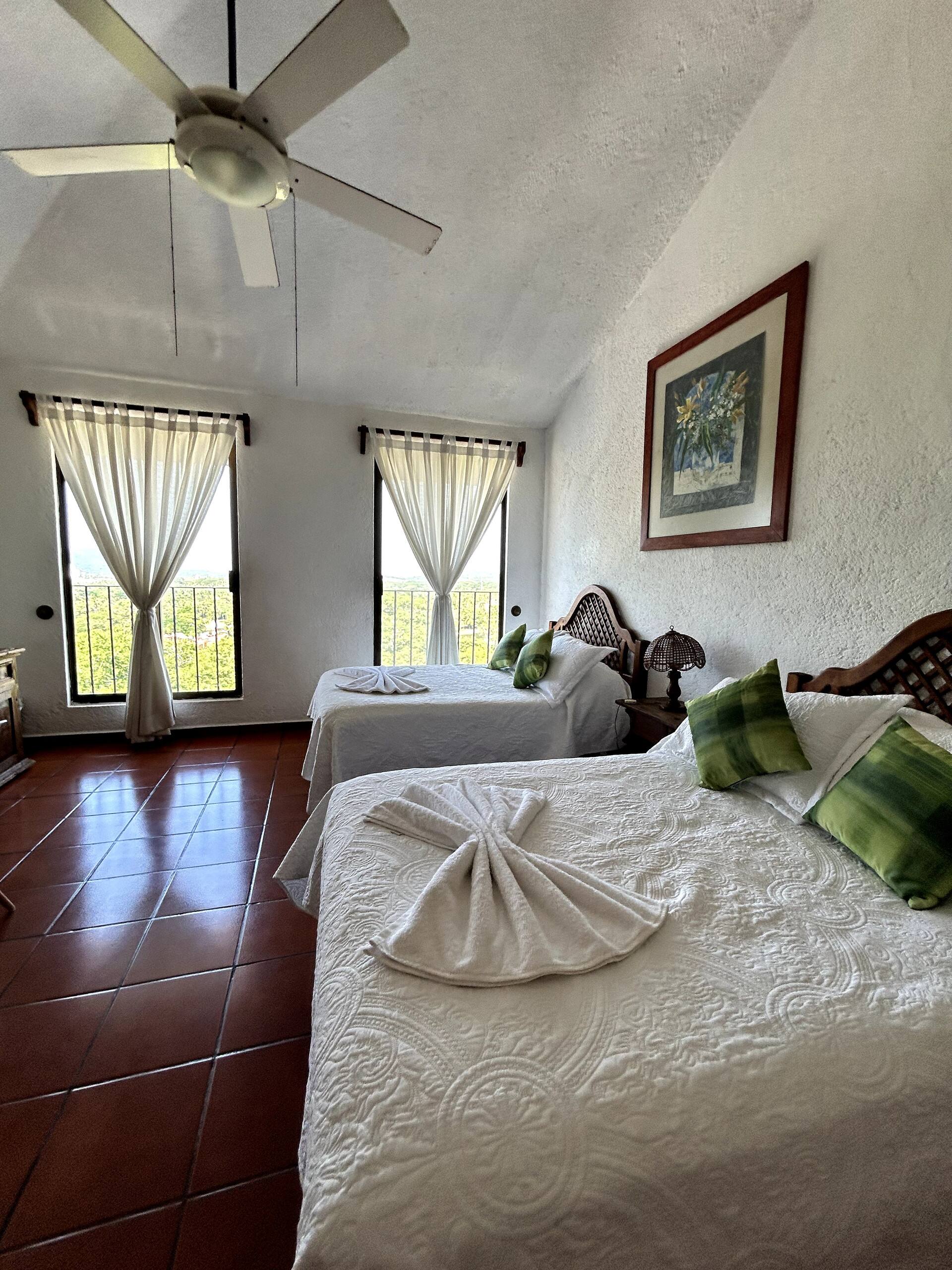 gray padded chaise couch beside window