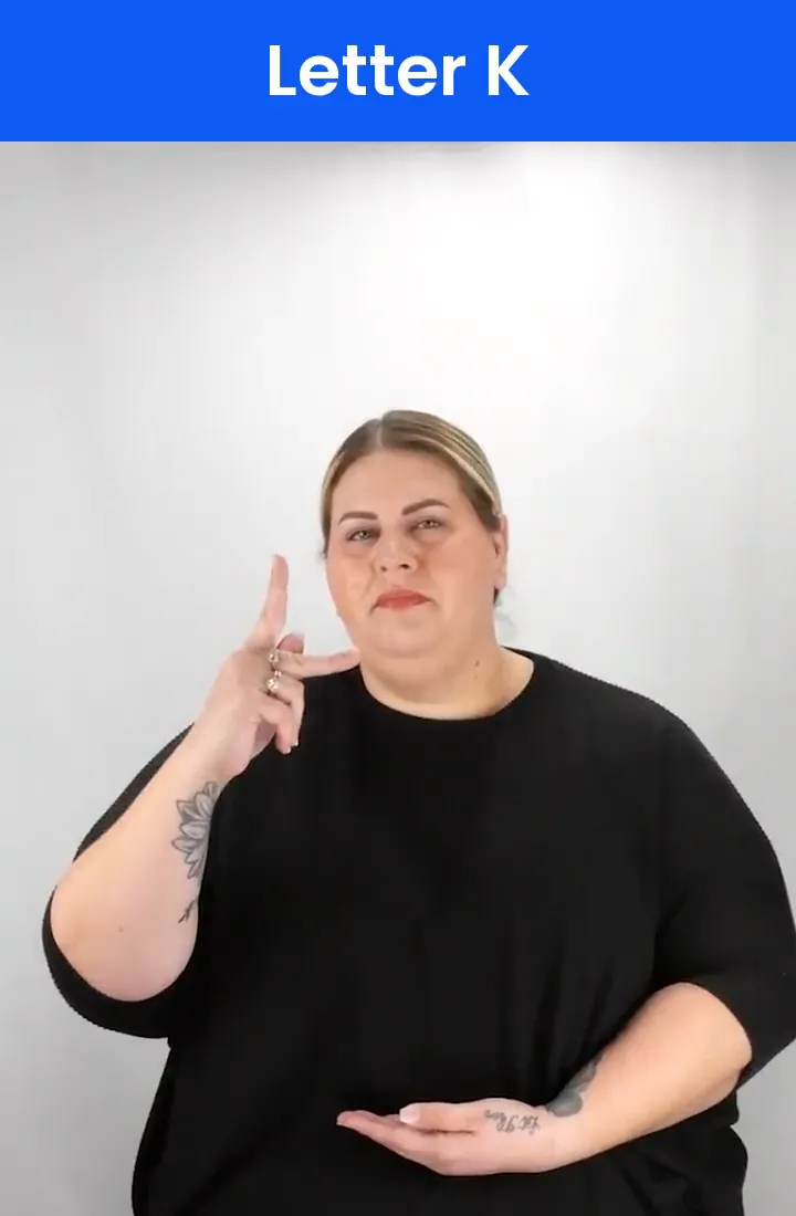 A Deaf signer signs K in ASL