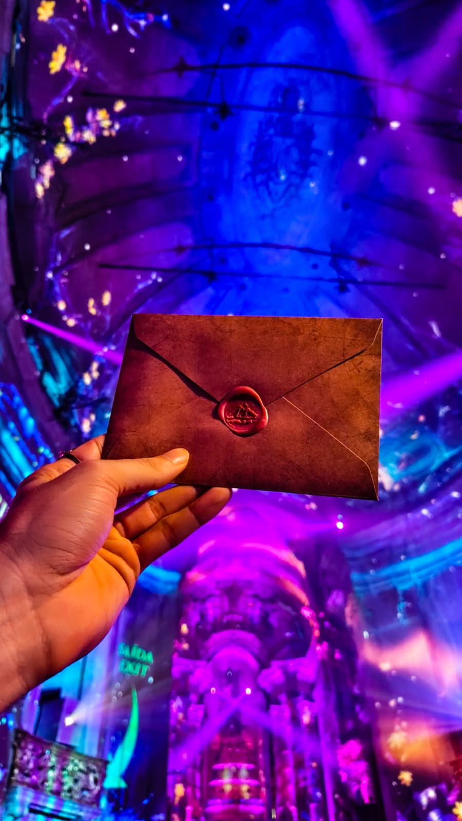 A woman lying down on a soft surface with her eyes closed, bathed in warm sunlight filtering through leaves. Her face has a natural glow, reflecting relaxation and tranquility in a serene spa-like setting.