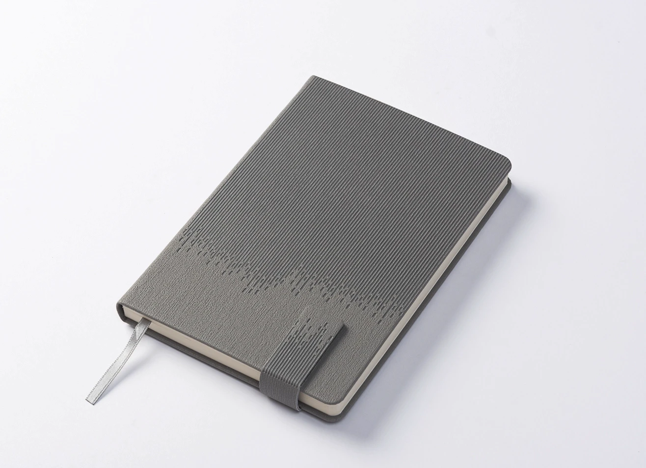 Angled view of ribbed texture grey journal with ribbon bookmark