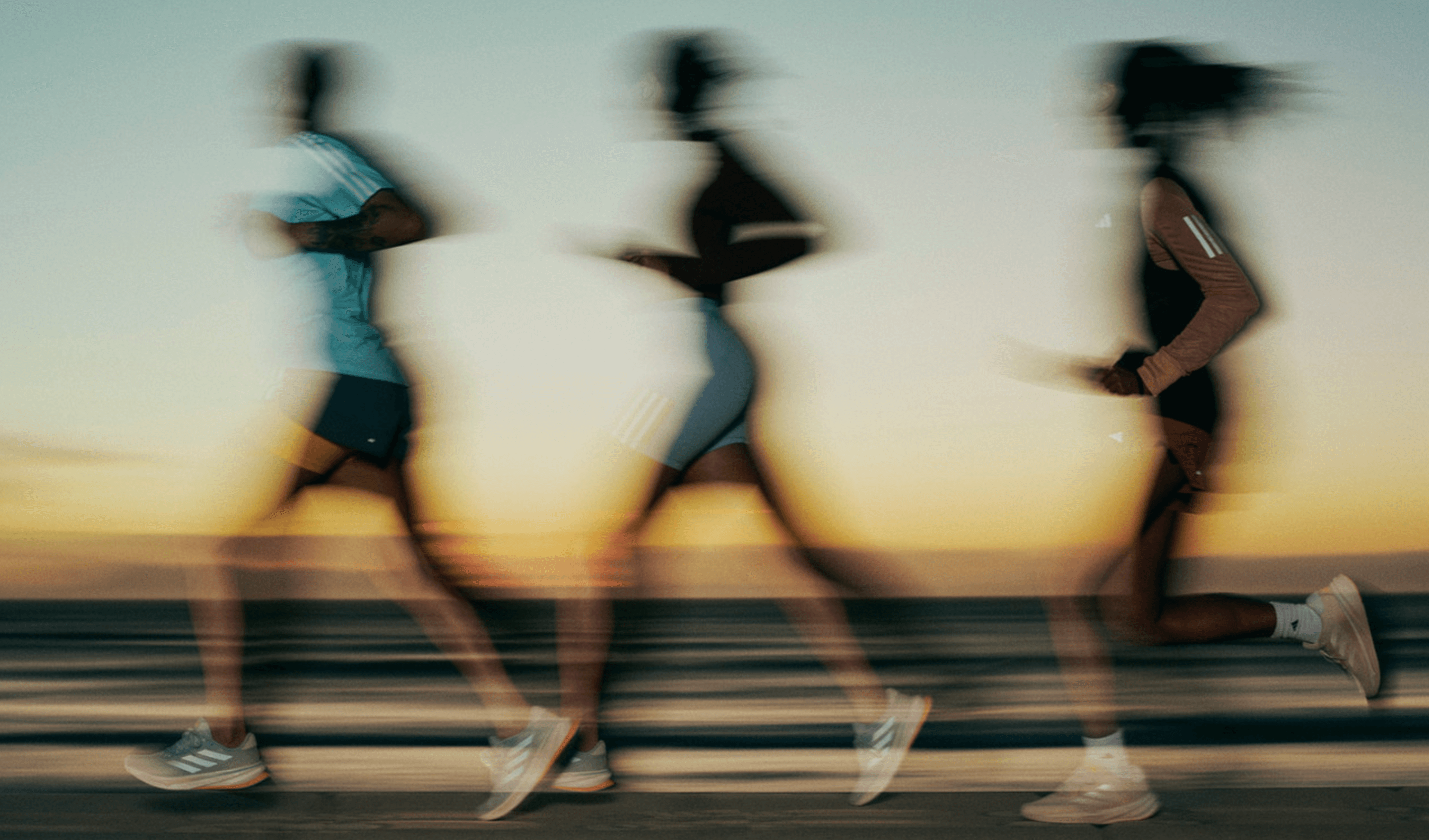 Blurred motion photo of people running, representing teamwork and athletic energy.