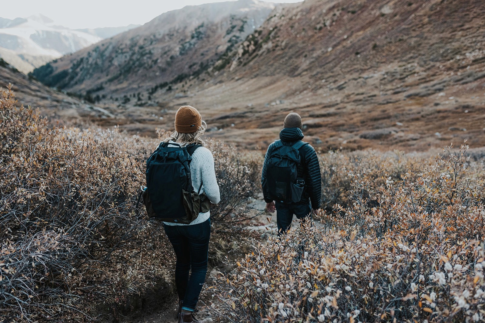 Jenny Smiley Photography Andrea & Colin hiking through scrub brush in Aspen Colorado