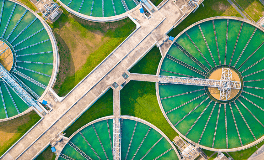 overhead shot of circular green factory roofs