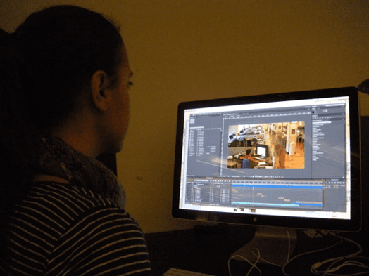 A photo of a person working on a photo at a computer.