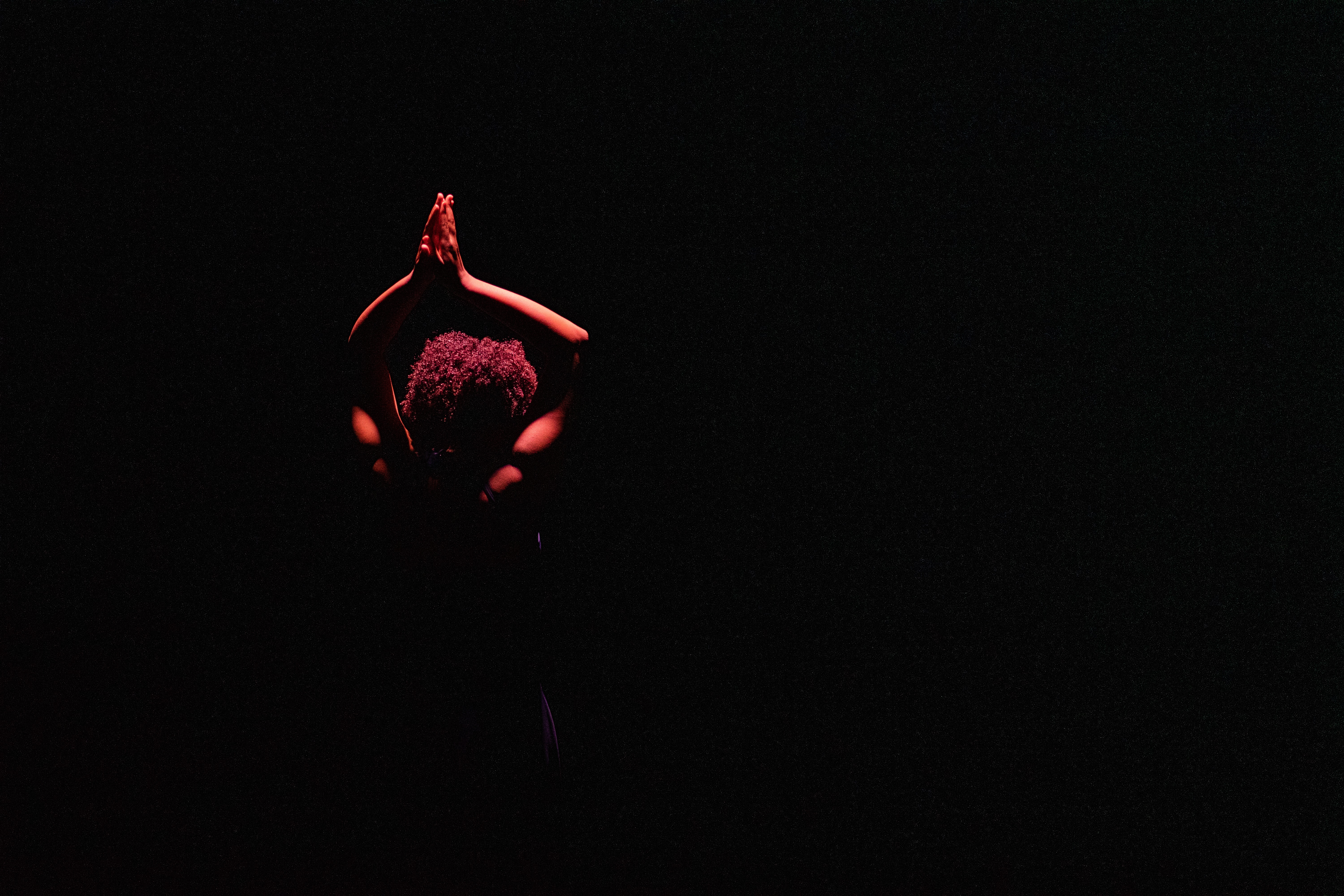 two people in a workspace working on their laptops 