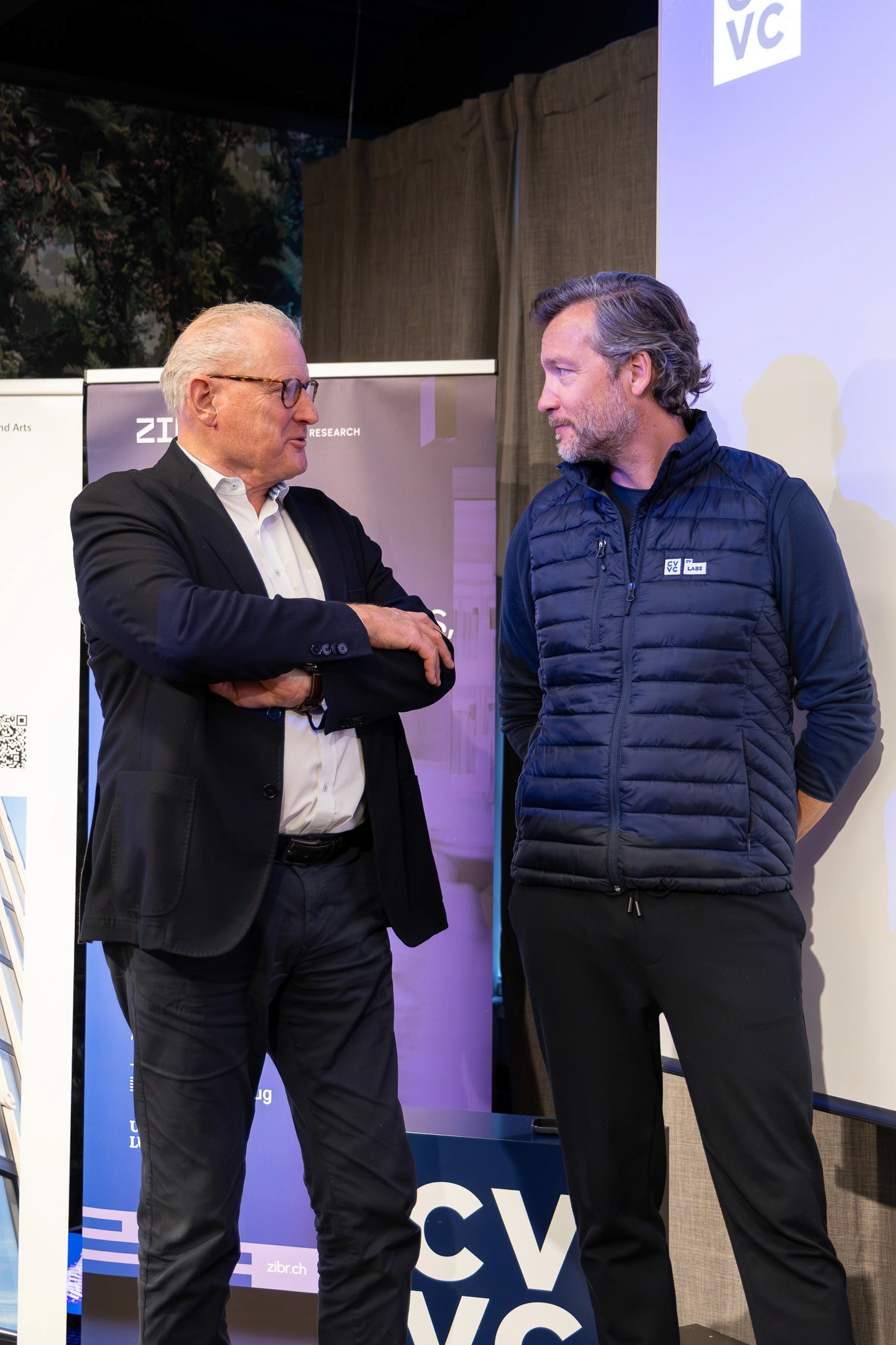 Conference guests in conversation during a networking event.