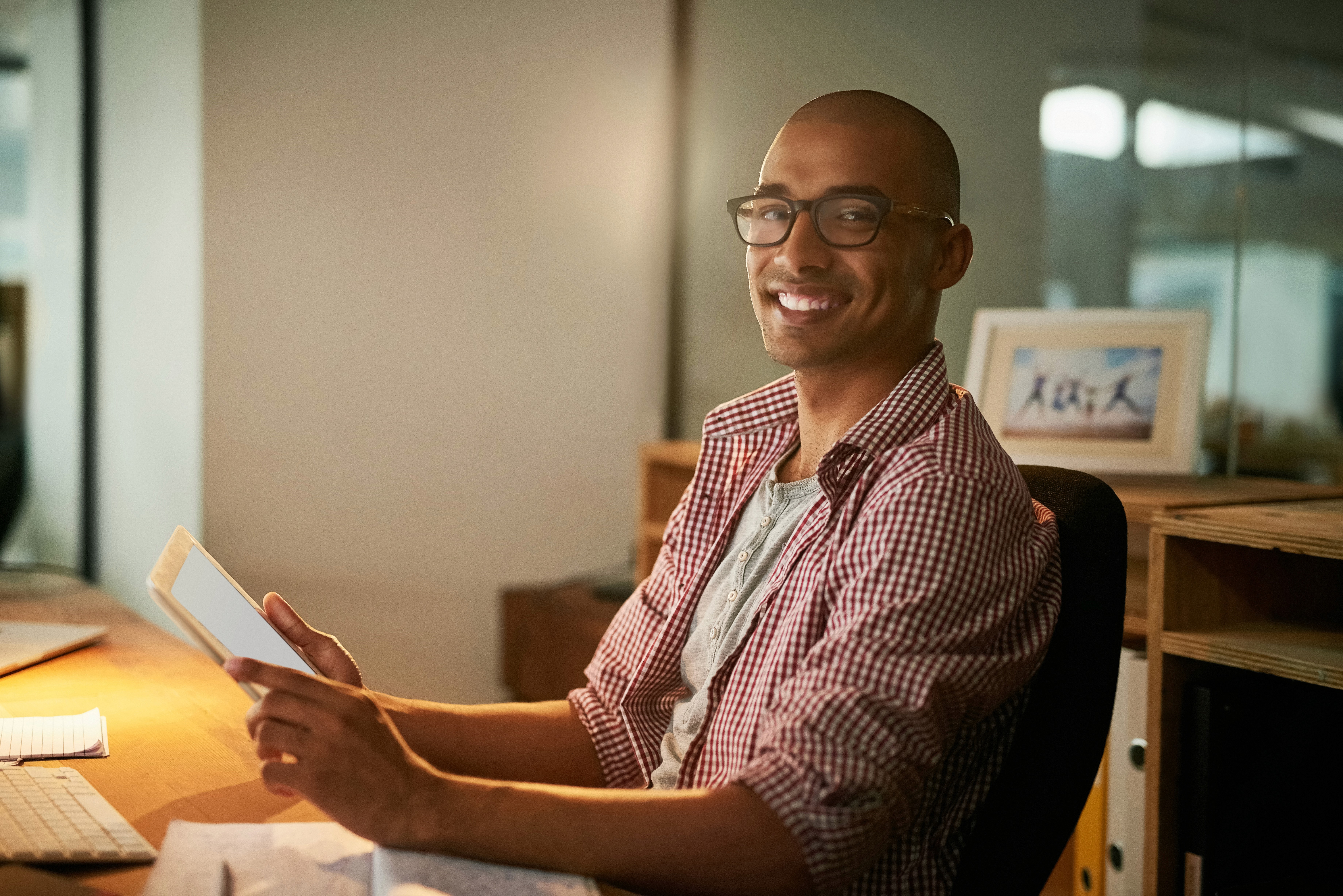 woman sitting around table holding tablet