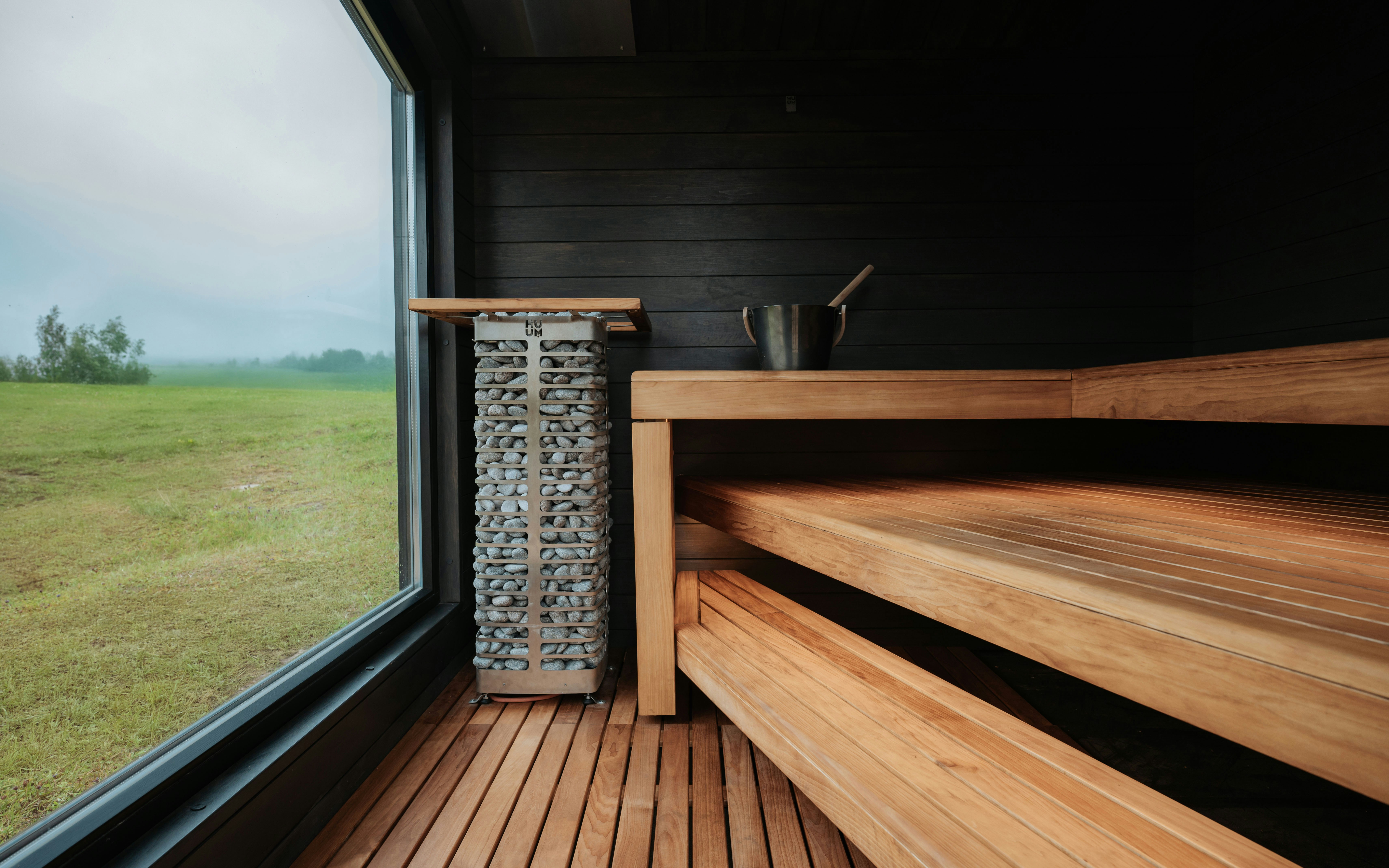 Wooden sauna with stone heater and large window