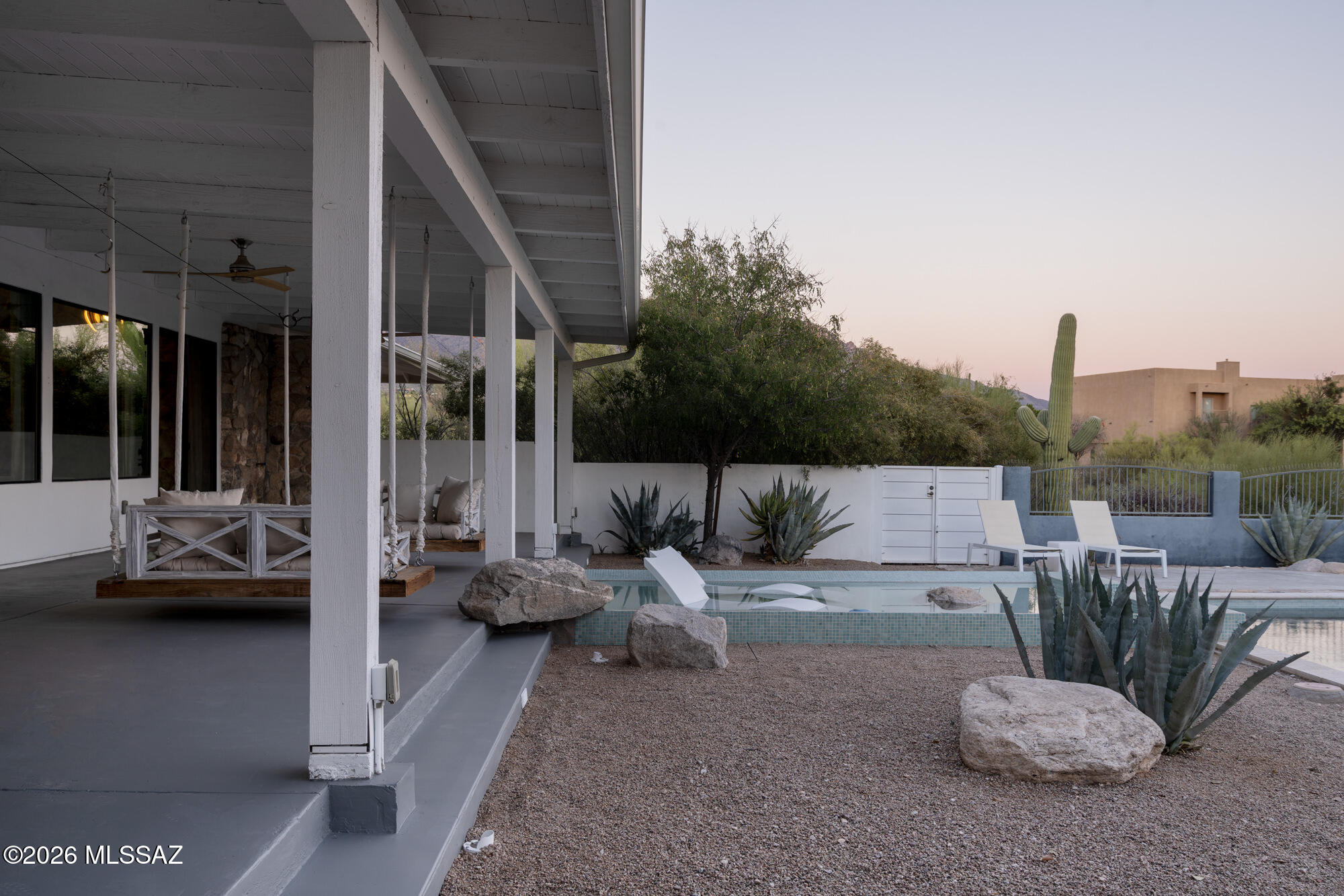 gift registry page with two images: modern villa with infinity pool and person in white dress and straw hat on sandy beach