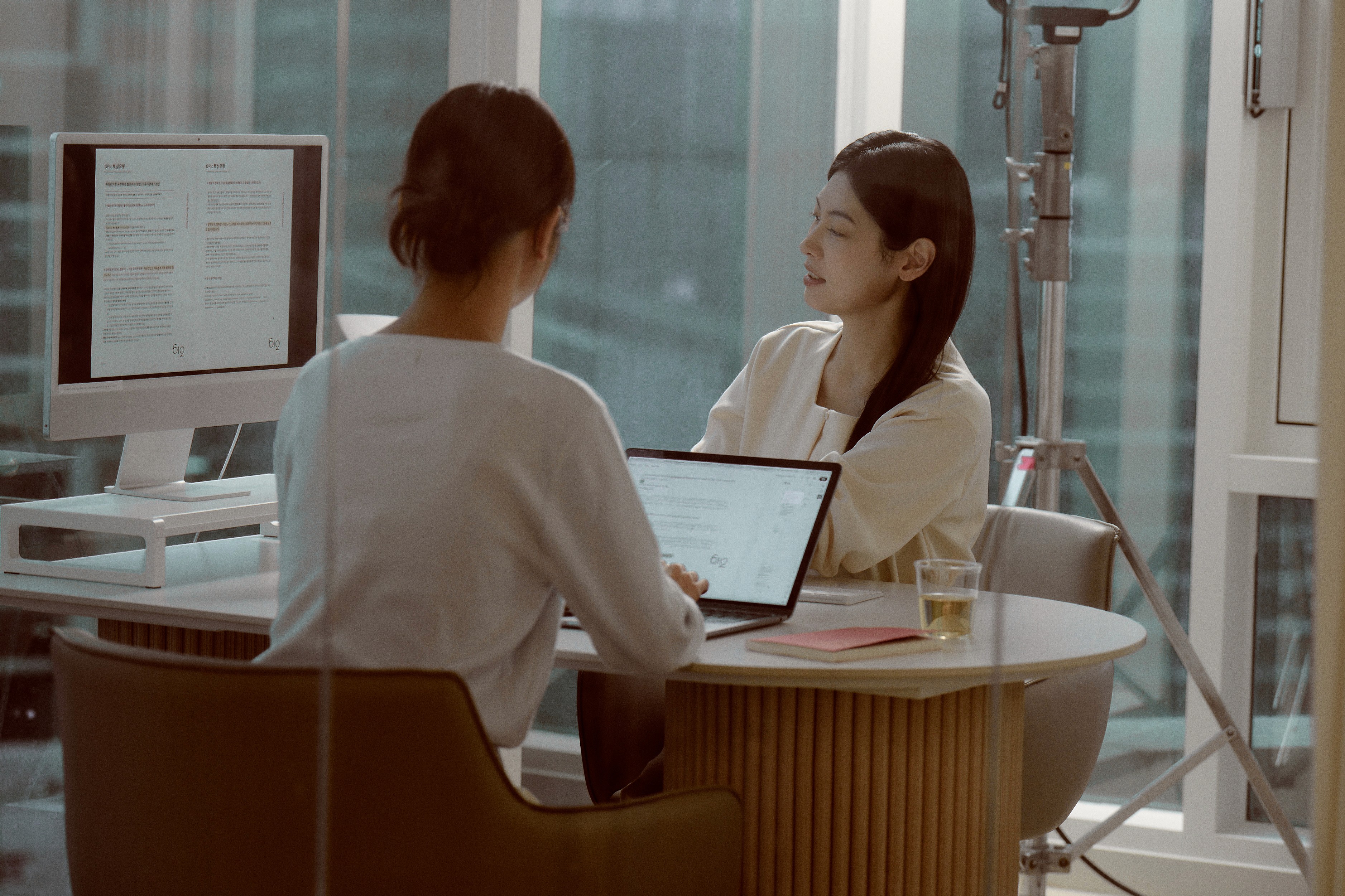 Two students smiling during a language learning session at 612 Academy, reflecting an engaging and human-centered learning experience.
