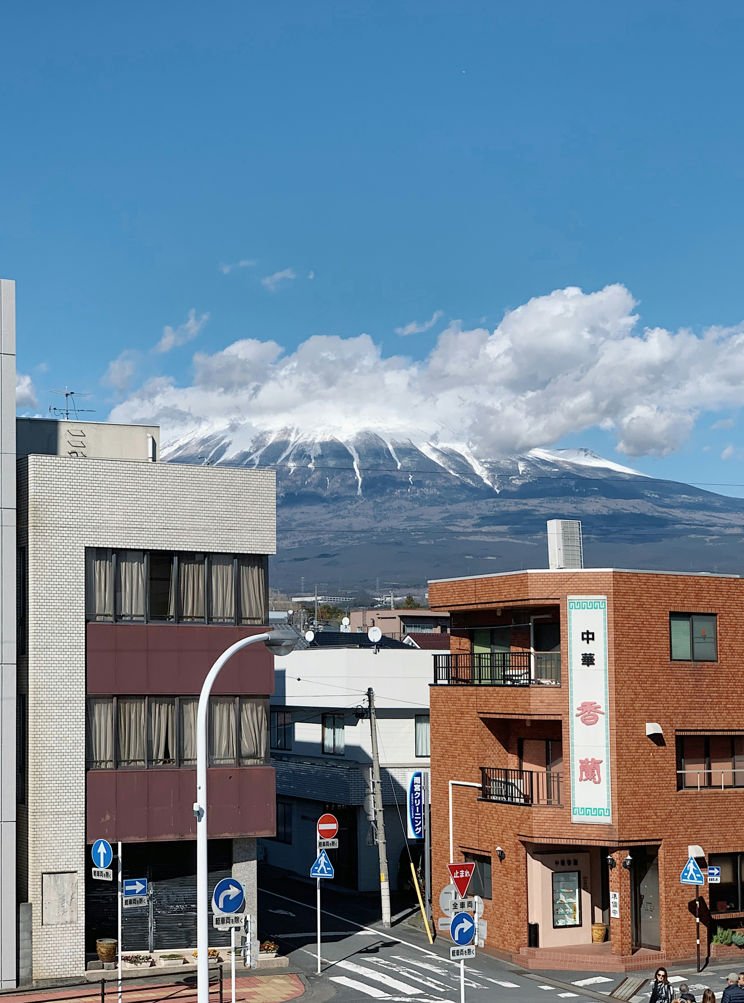 a city with buildings and mountains in the background