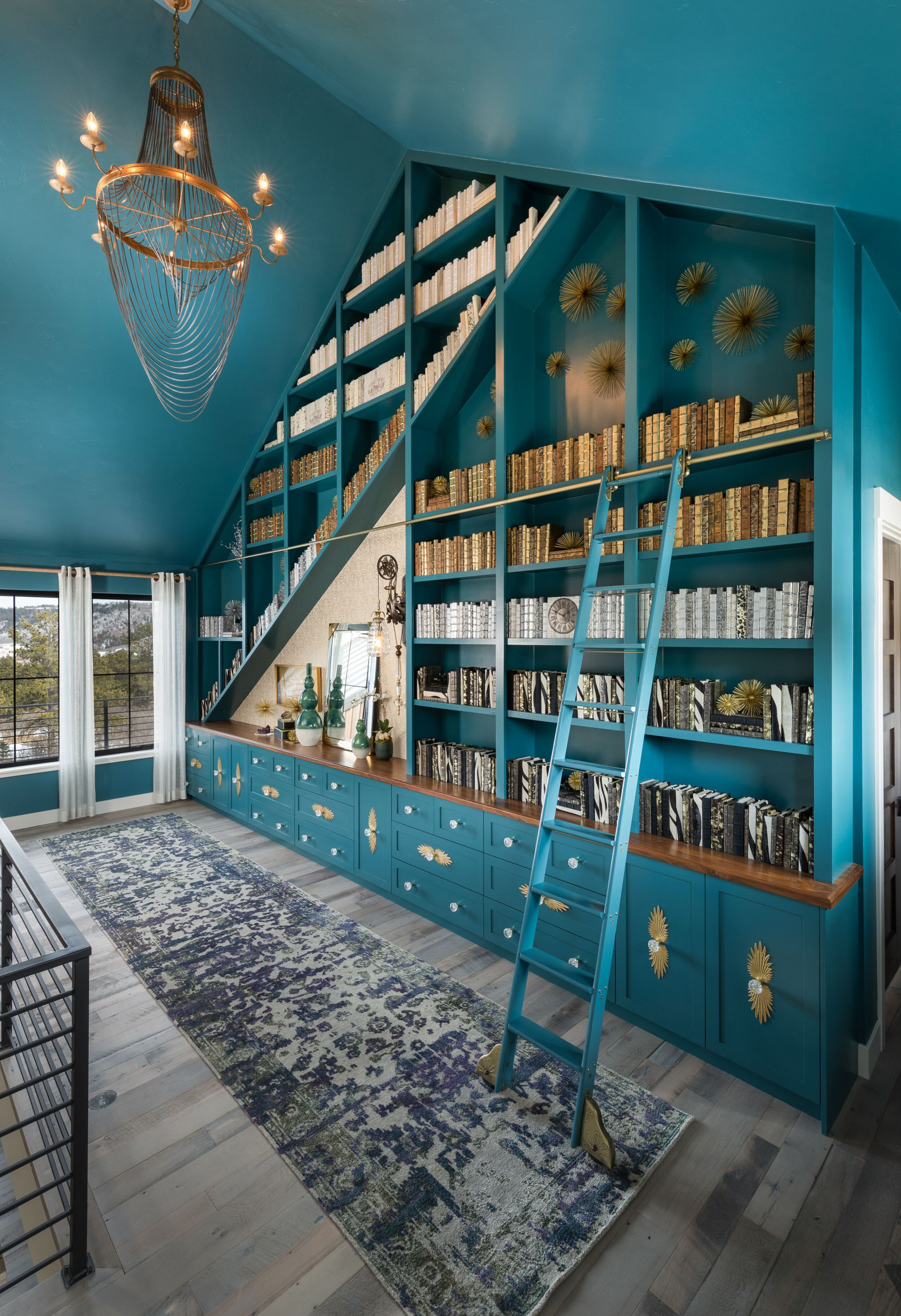 Library with teal shelves, ladder, and patterned rug