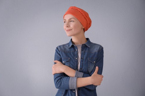 Young woman with cancer with a satisfaction, calm smile