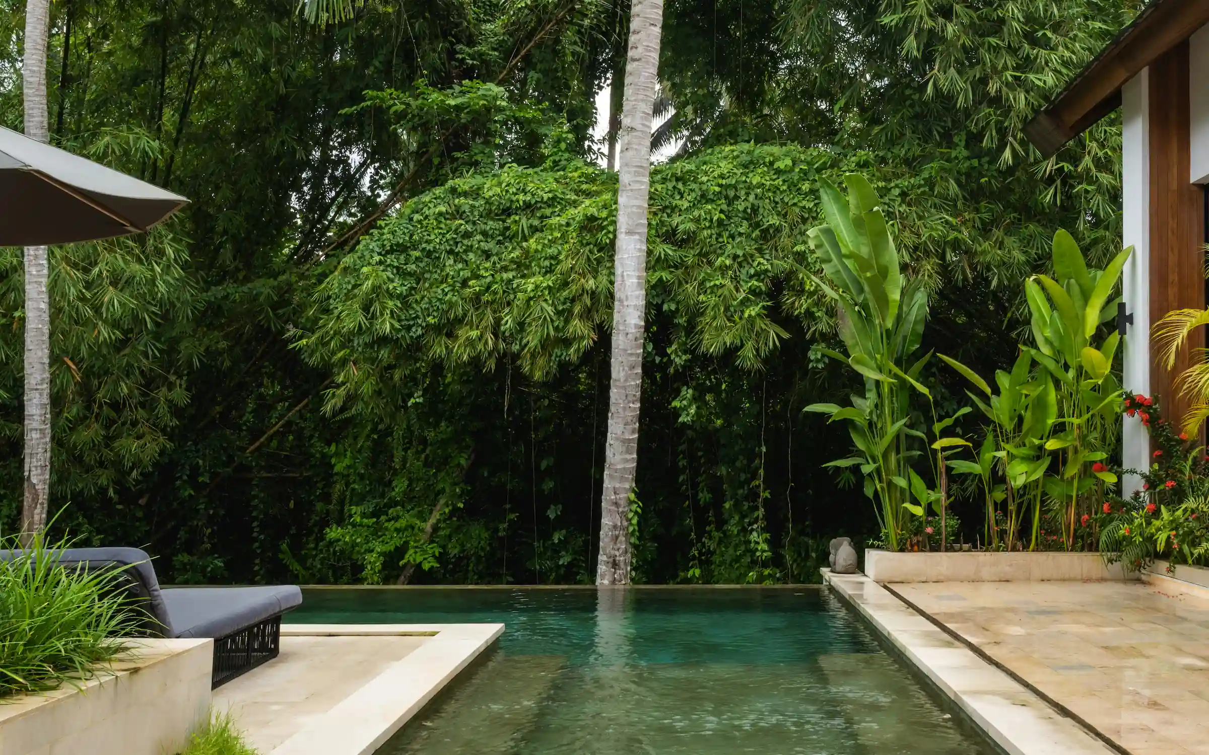 Modern timber-clad residence with horizontal wood facade and geometric volumes set on manicured lawn