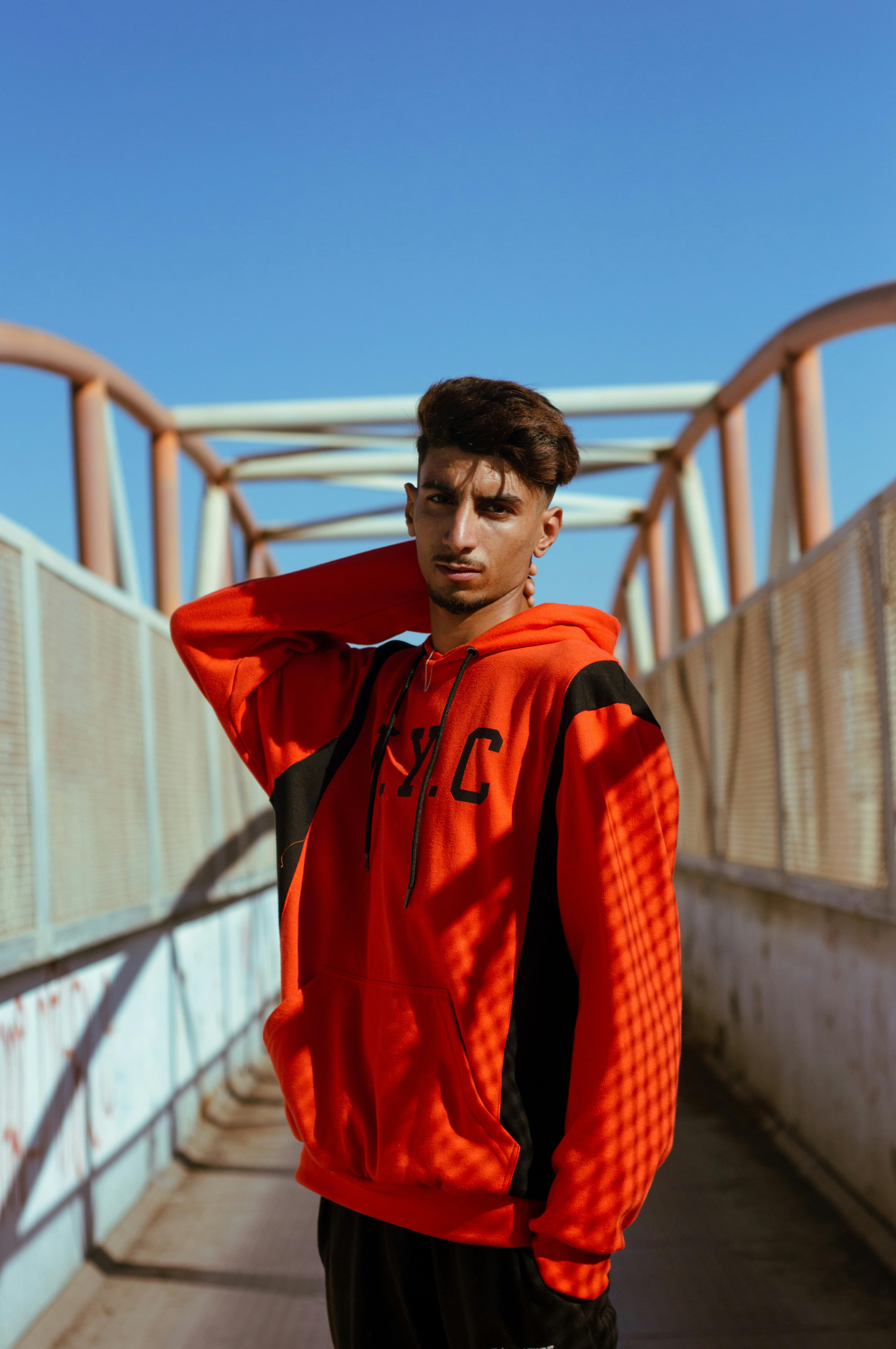 young-man-in-a-red-hoodie-posing-on-a-modern-casablanca-bridge. - yahya-boudi (pexels)