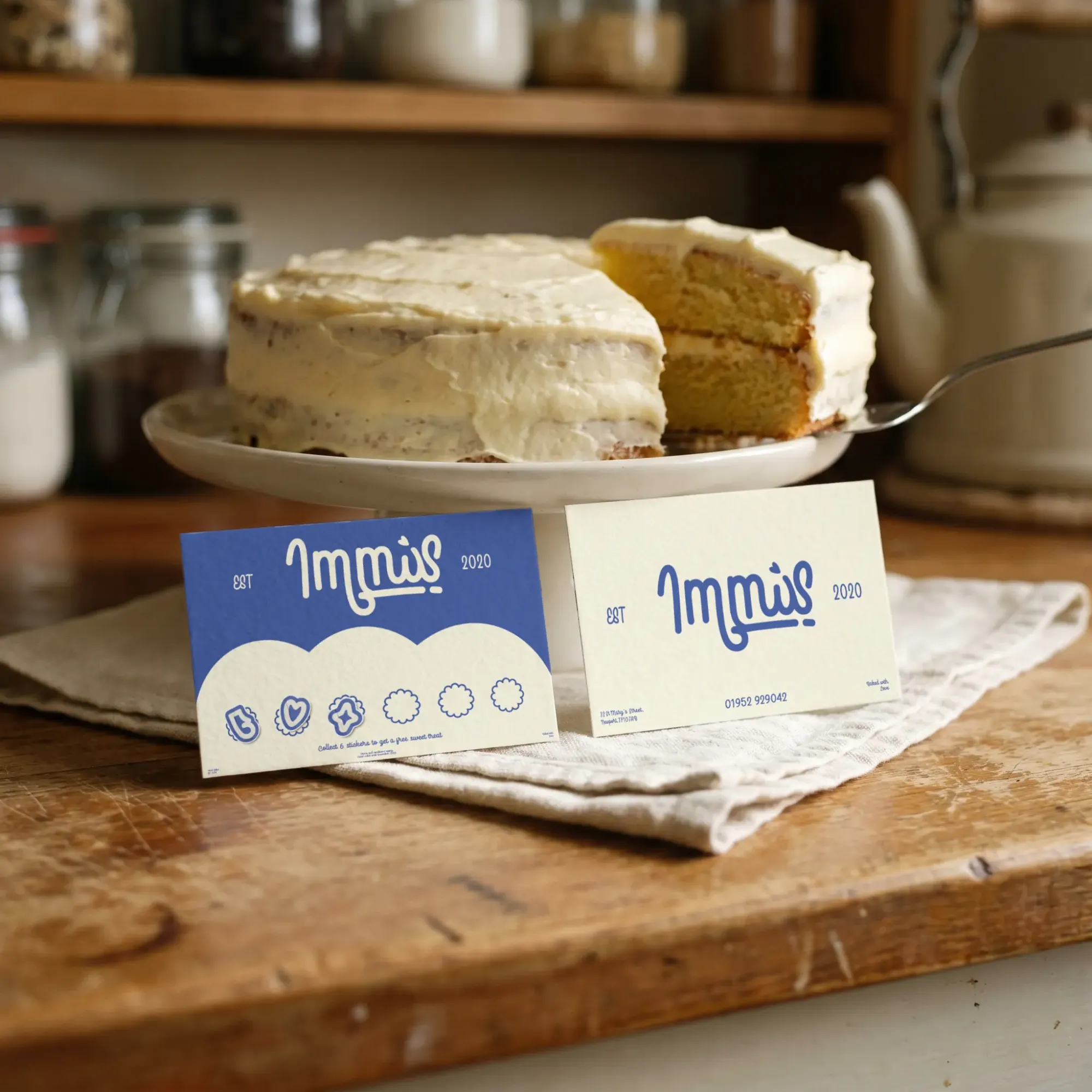 Immis business cards beside a sliced sponge cake