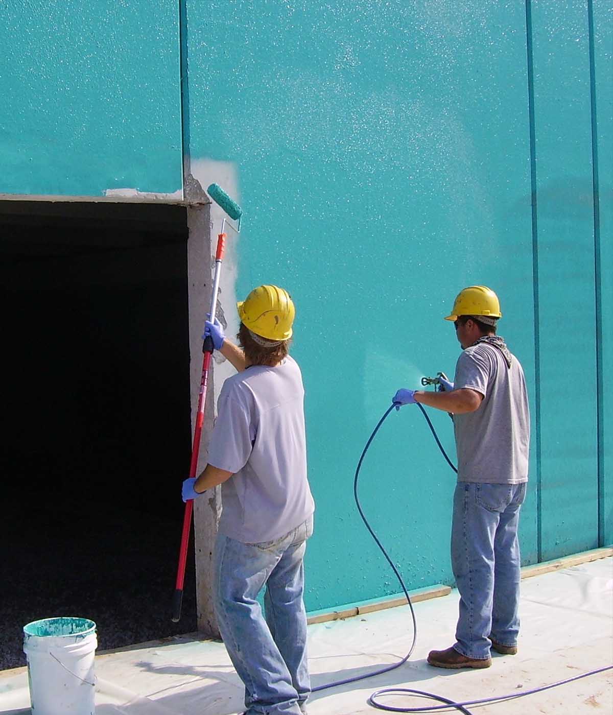 Rub-R-Wall applicators spraying waterproofing