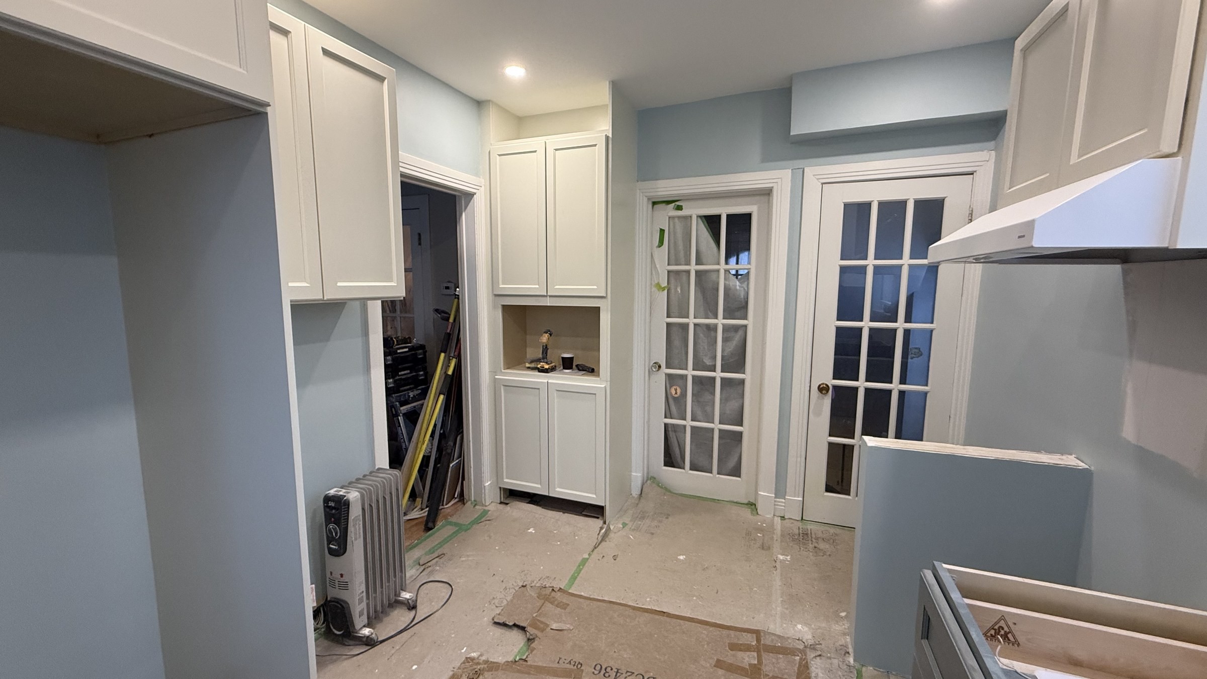 Two-tone cabinetry being installed in the NDG kitchen