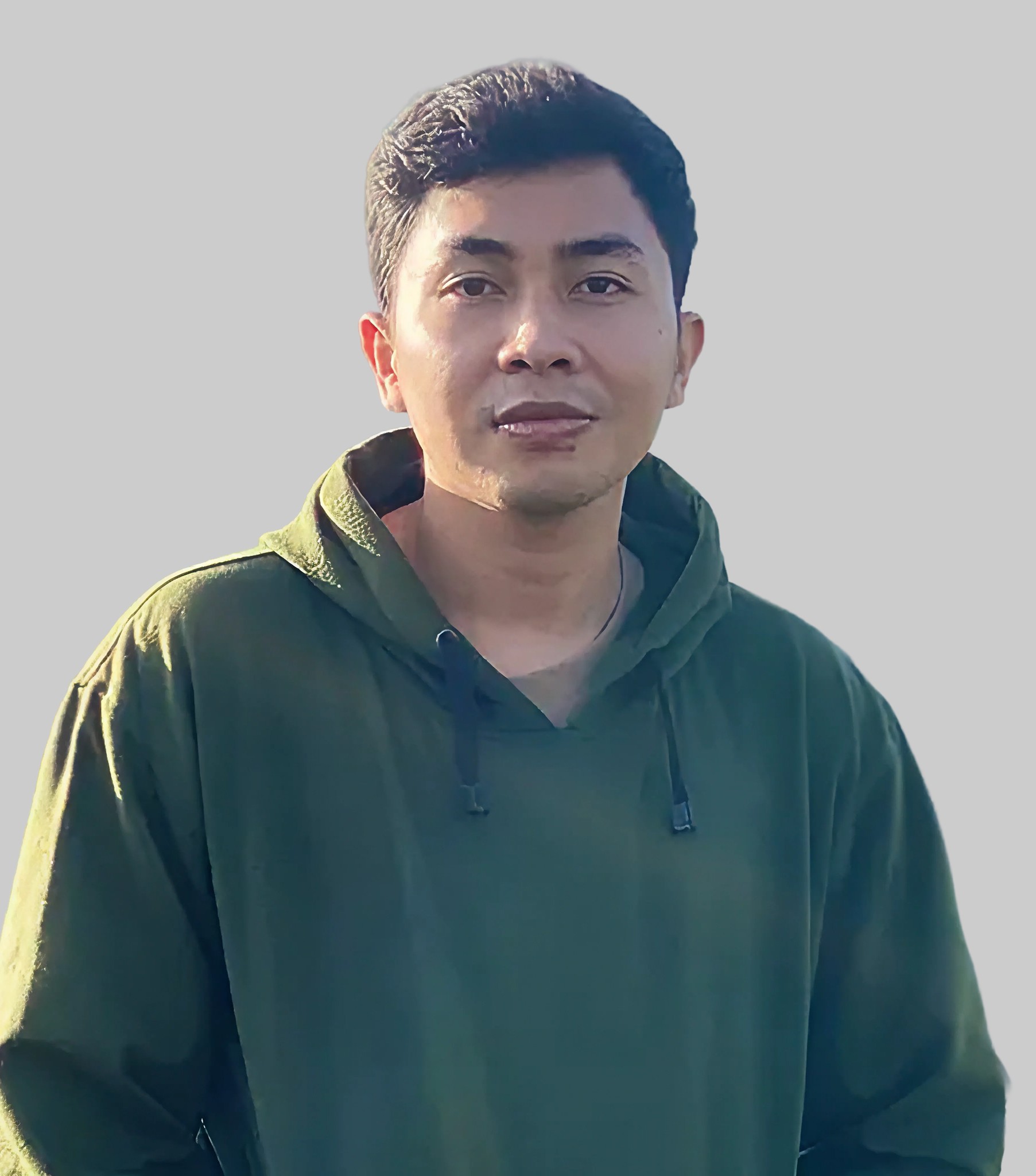 A man with glasses and a brown shirt, crossing his arms.