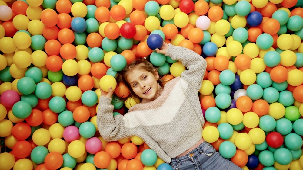 Close-up of lush, dark green leaves, some glossy and wet, against a muted background.
