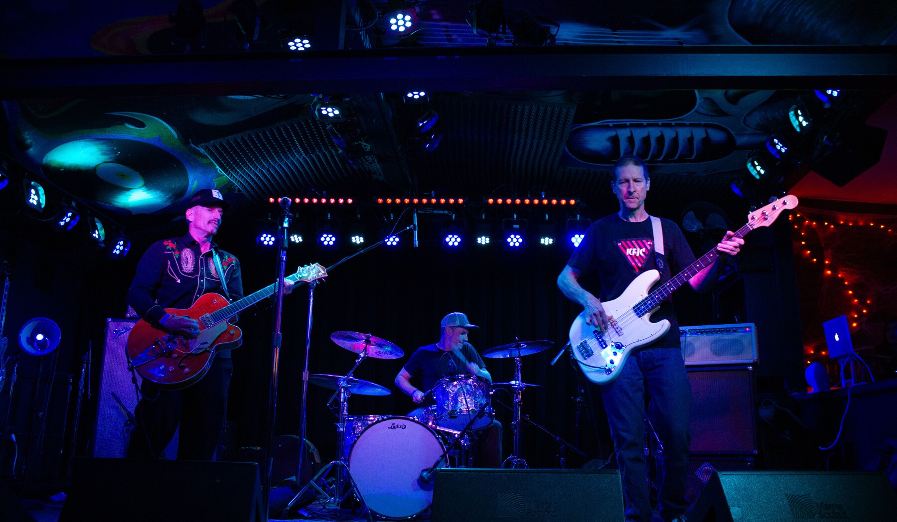 Dead Kampers on stage under the cool blue lights.