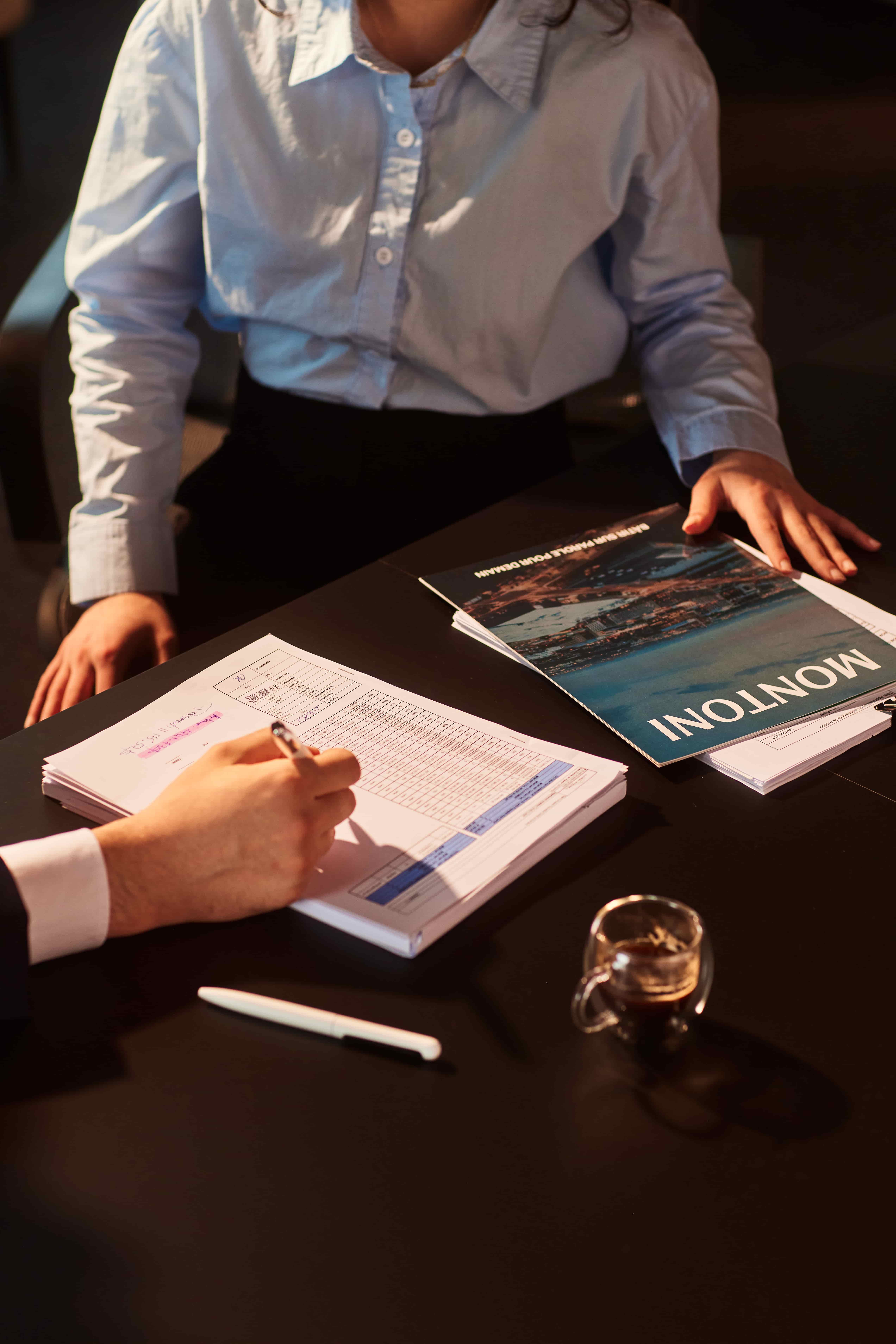 Documents and planning materials on a desk, representing customized solutions tailored to client needs.