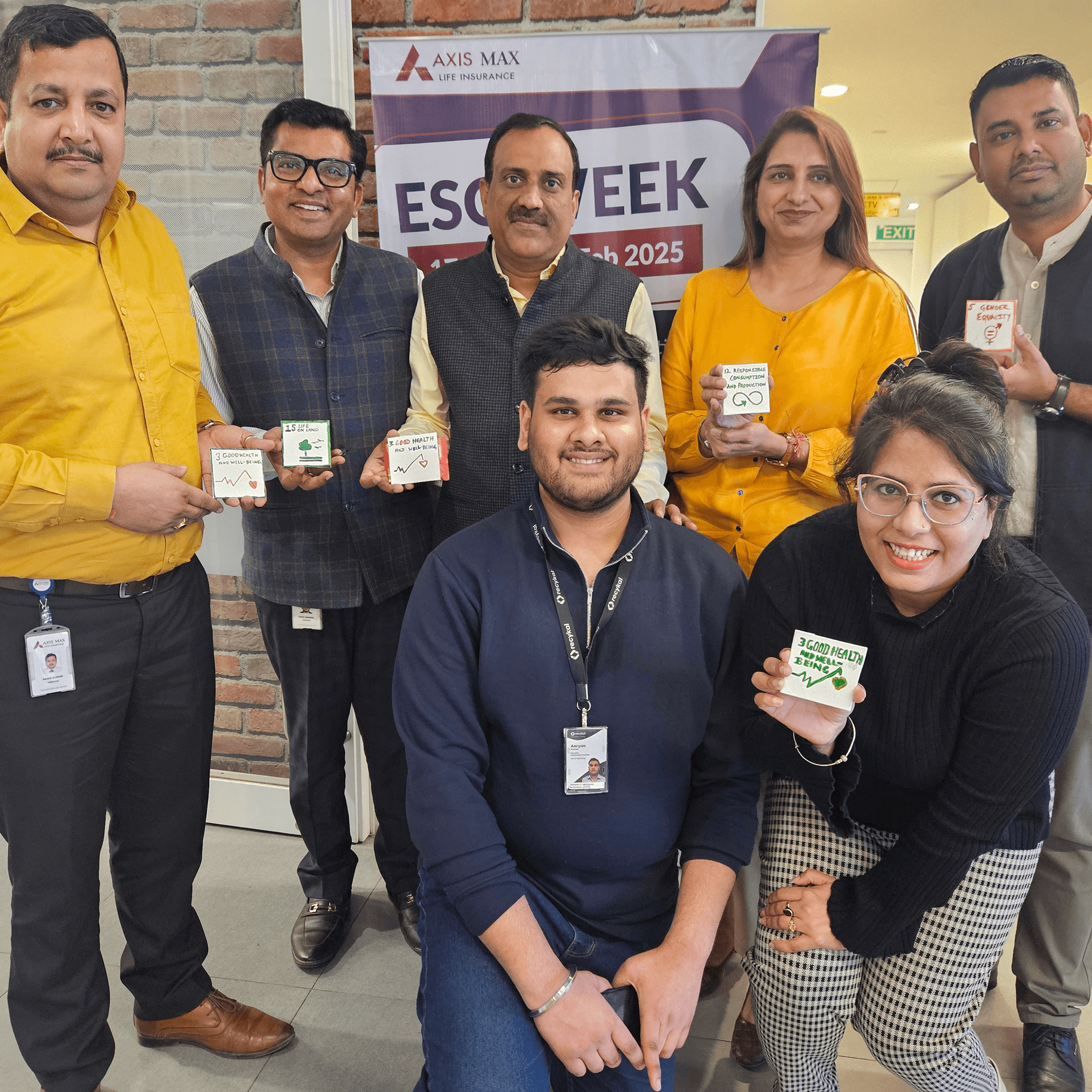 Woman in red outfit poses by a red telephone booth.