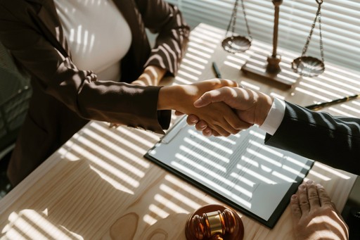 Closeup of business handshake symbolizing partnership, trust, and onboarding with EU compliance experts.