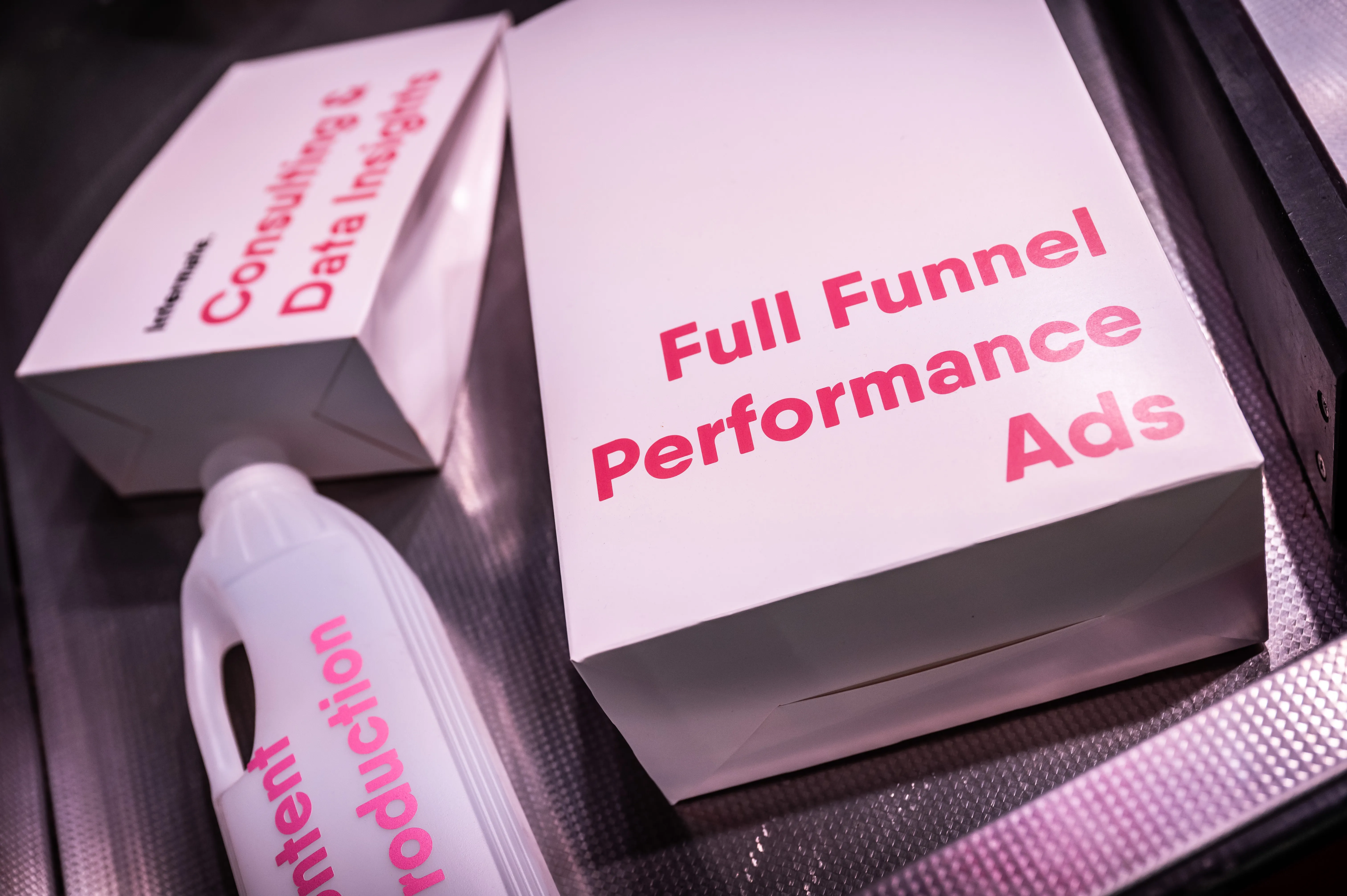 Product boxes labeled Full Funnel Performance Ads and Consulting & Data Insights as supermarket goods at the Intermate booth.