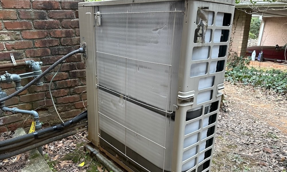 Air source heat pump outdoor unit struggling in cold winter conditions compared to mild autumn operation — explaining why heat pump performance drops as temperatures fall