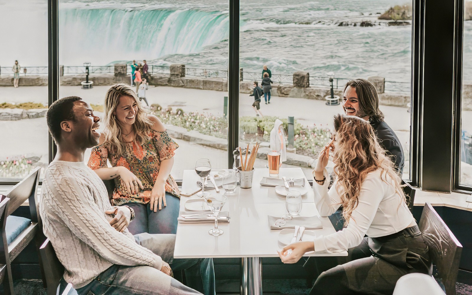Dining with a view of Niagara Falls on a Toronto day tour with Hornblower Cruise.
