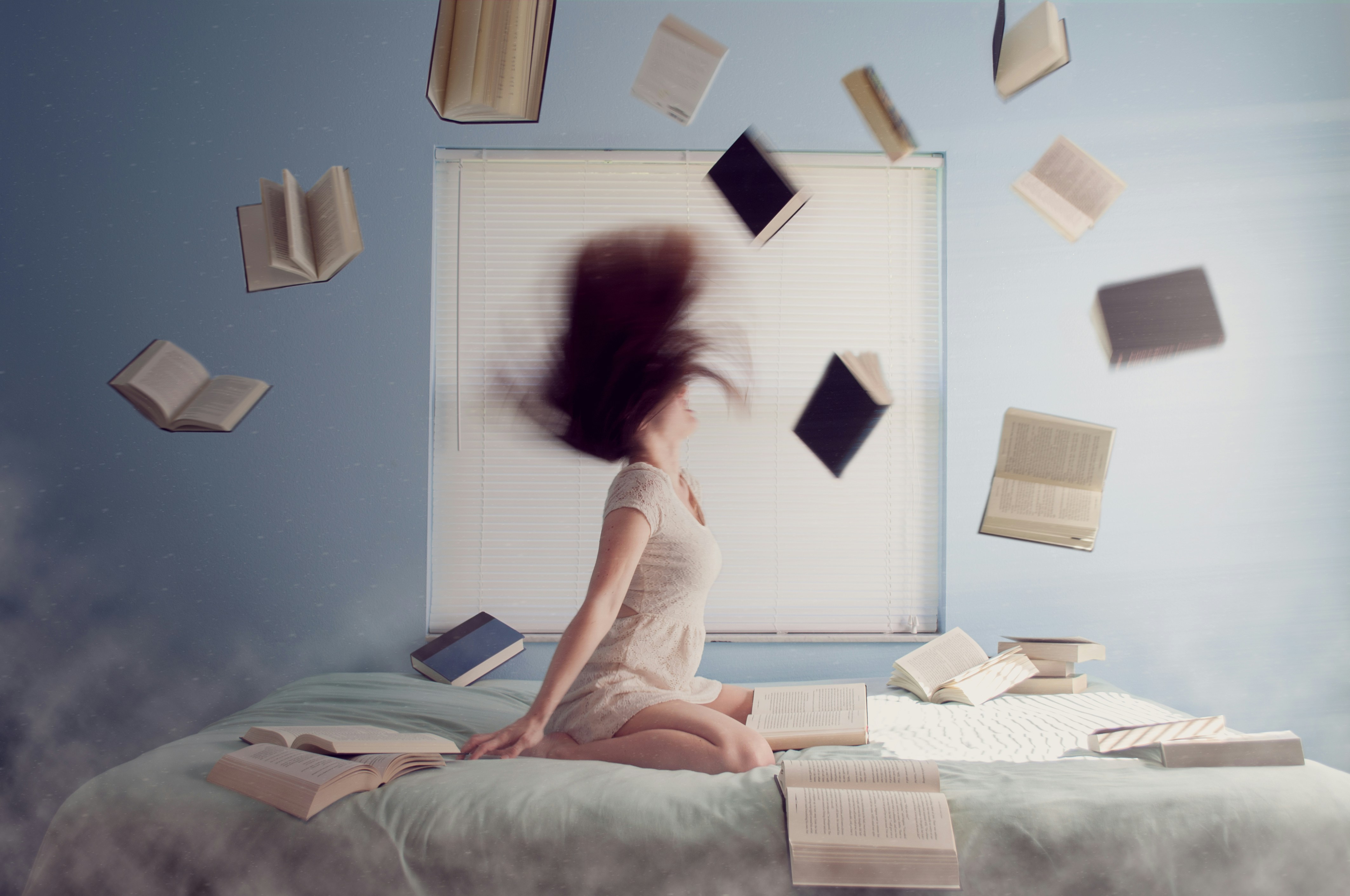 A Person with lots of books around them to showcase that their are fatigued by their emails