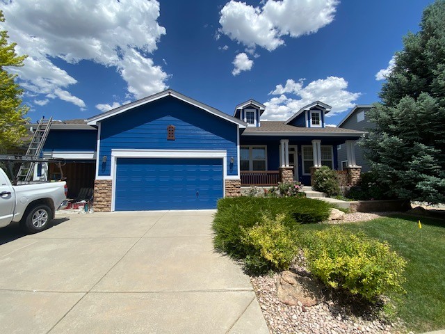 Residential exterior after repainting in a new blue and white colour scheme.
