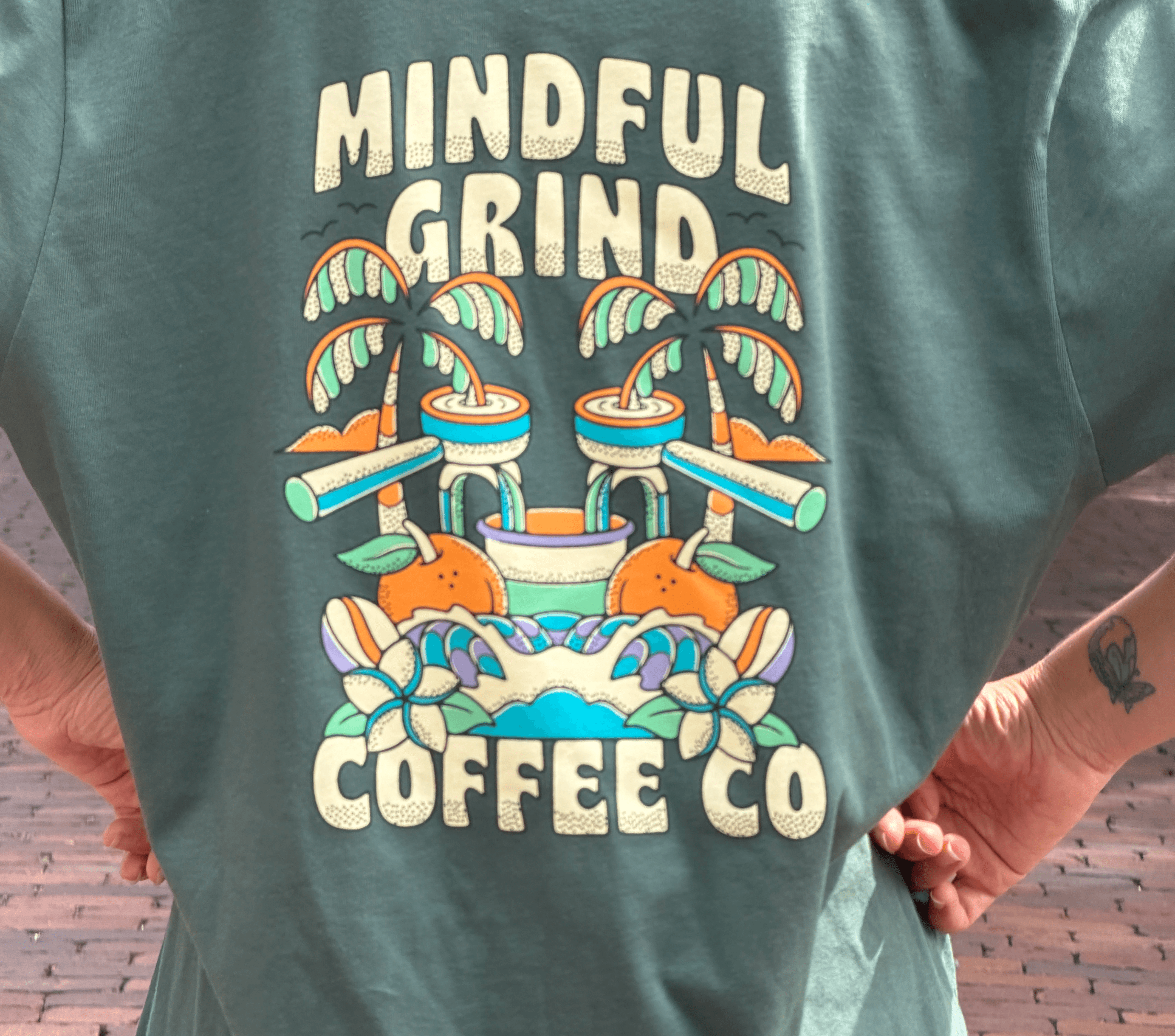 A customer wearing a Mindful Grind Coffee Co. shirt